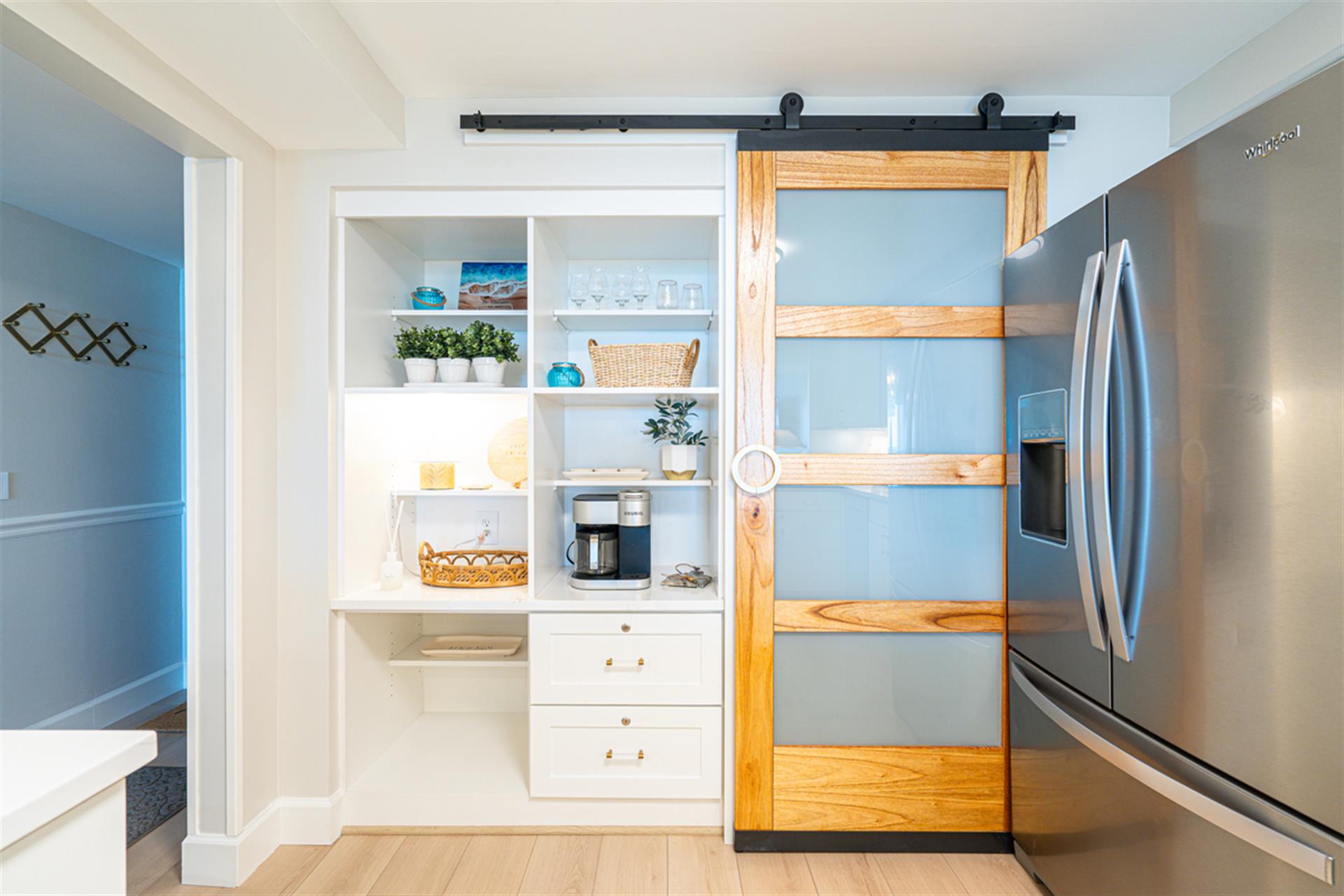Your stylish pantry features a charming barn door and organized shelving, perfect for storing snacks and cooking essentials during your stay.