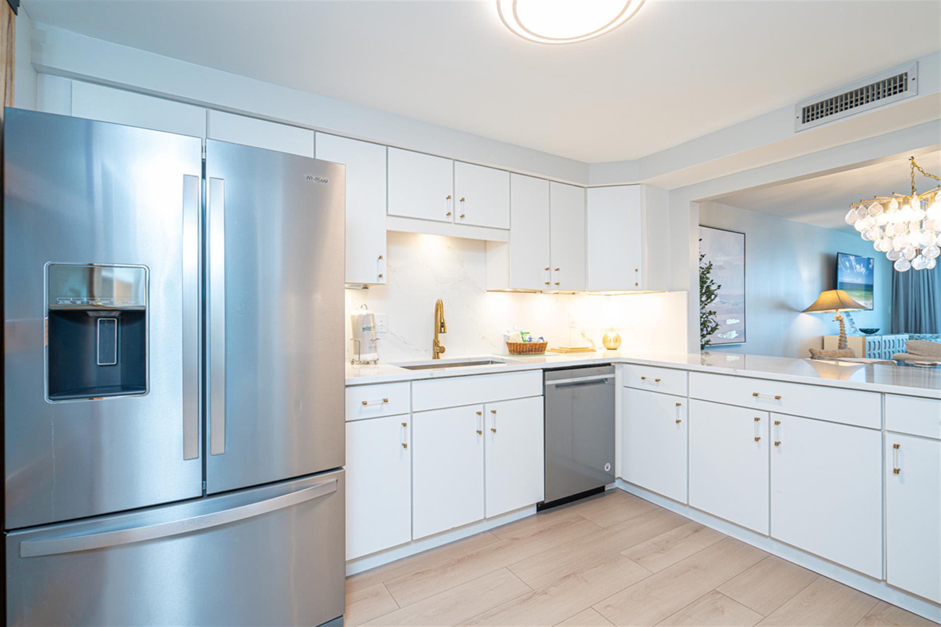 Step into your pristine modern kitchen featuring sleek white cabinetry, stainless steel appliances, and elegant countertops perfect for culinary adventures.