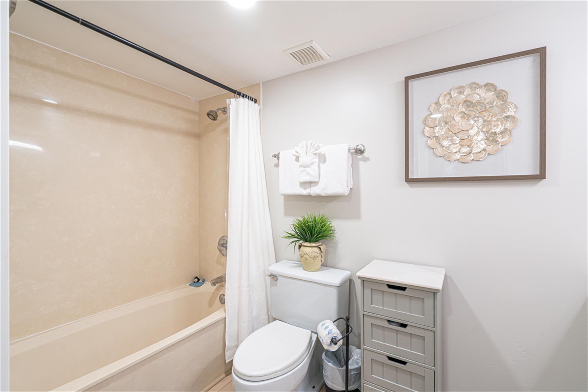 Refresh in your bright, clean bathroom featuring a full tub-shower combo and thoughtful touches for your comfort.