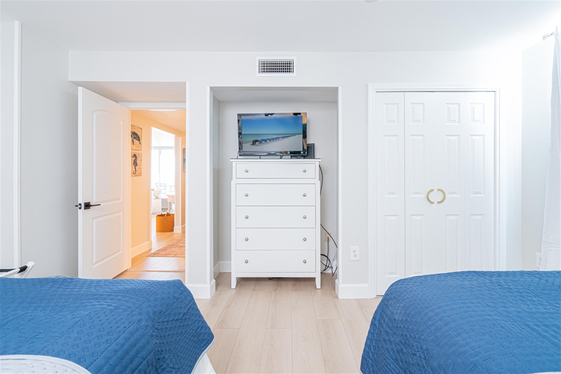 Unwind in your bright bedroom with two comfortable beds, built-in TV entertainment, and ample closet storage for all your vacation essentials.