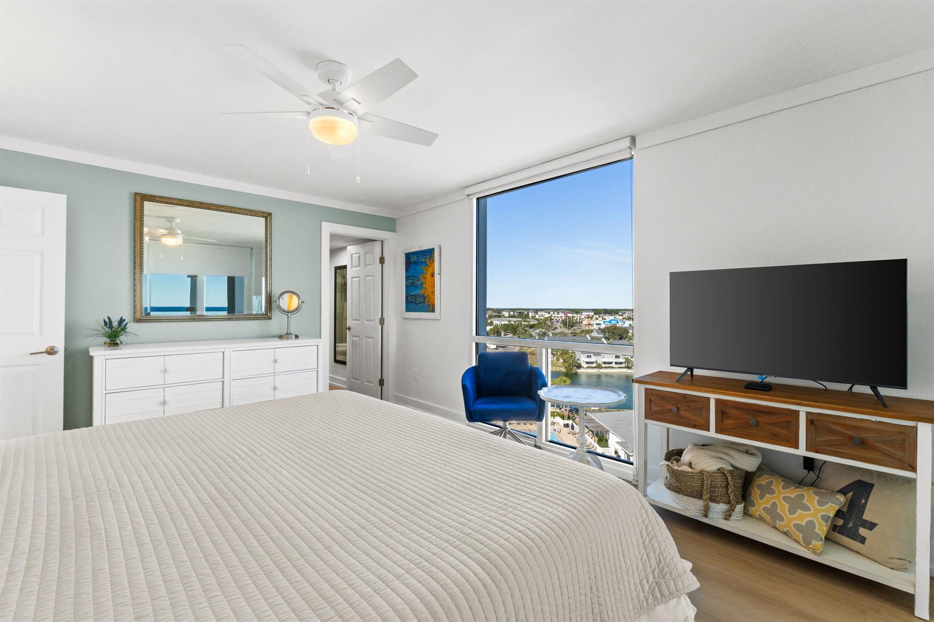 Wake up to stunning city views from your bright, airy bedroom with comfortable seating and entertainment center for ultimate relaxation.