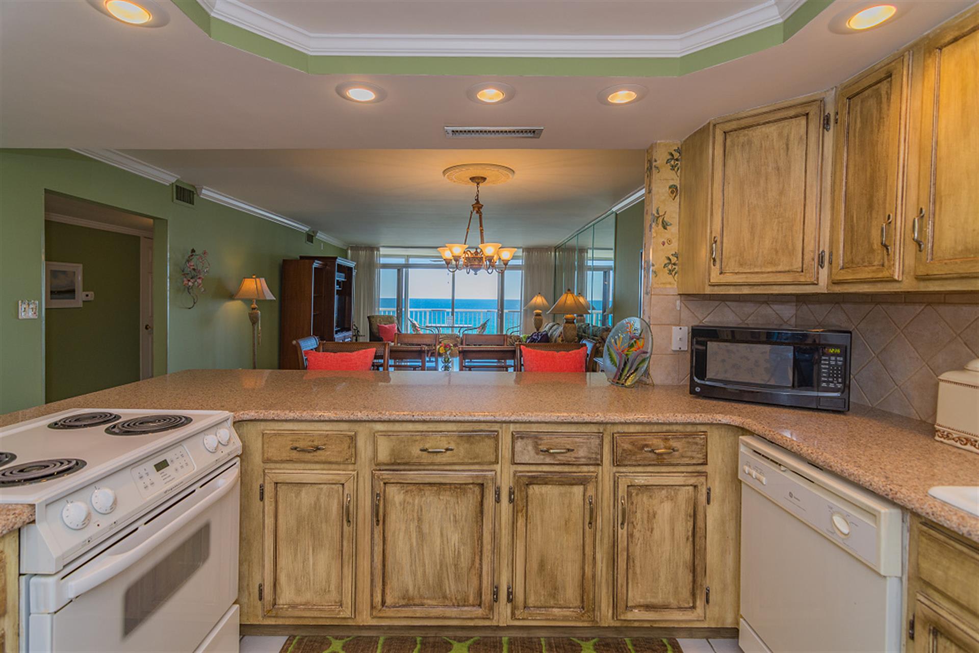 Your fully equipped kitchen opens to the living area, creating a seamless flow for cooking while enjoying ocean views and gathering spaces.