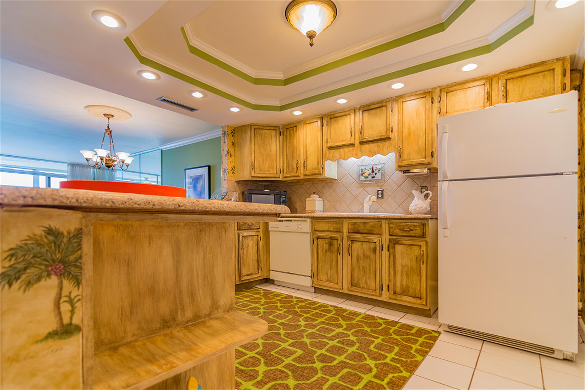 Your fully-equipped kitchen features warm wood cabinets, granite counters, and all appliances needed for memorable meals during your stay.