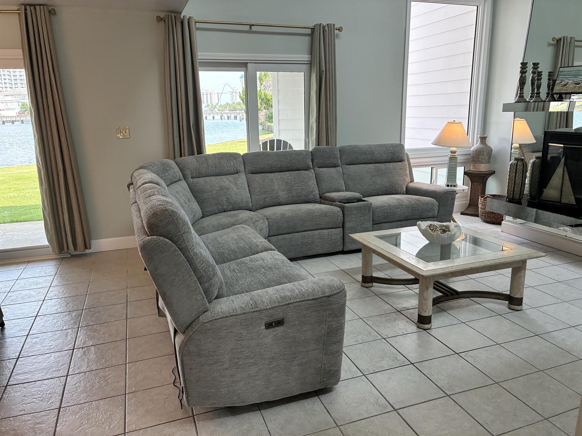 Unwind in your spacious living room with plush sectional seating and stunning lake views through oversized windows.