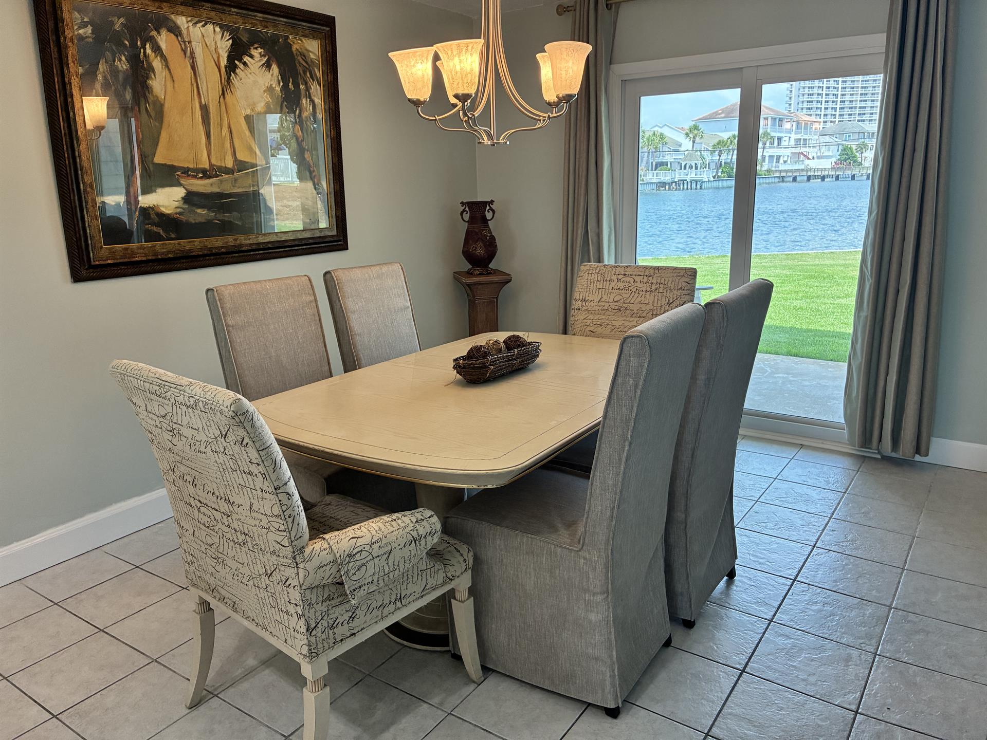 Enjoy memorable meals at your elegant dining table while gazing out at stunning waterfront views through your private patio doors.
