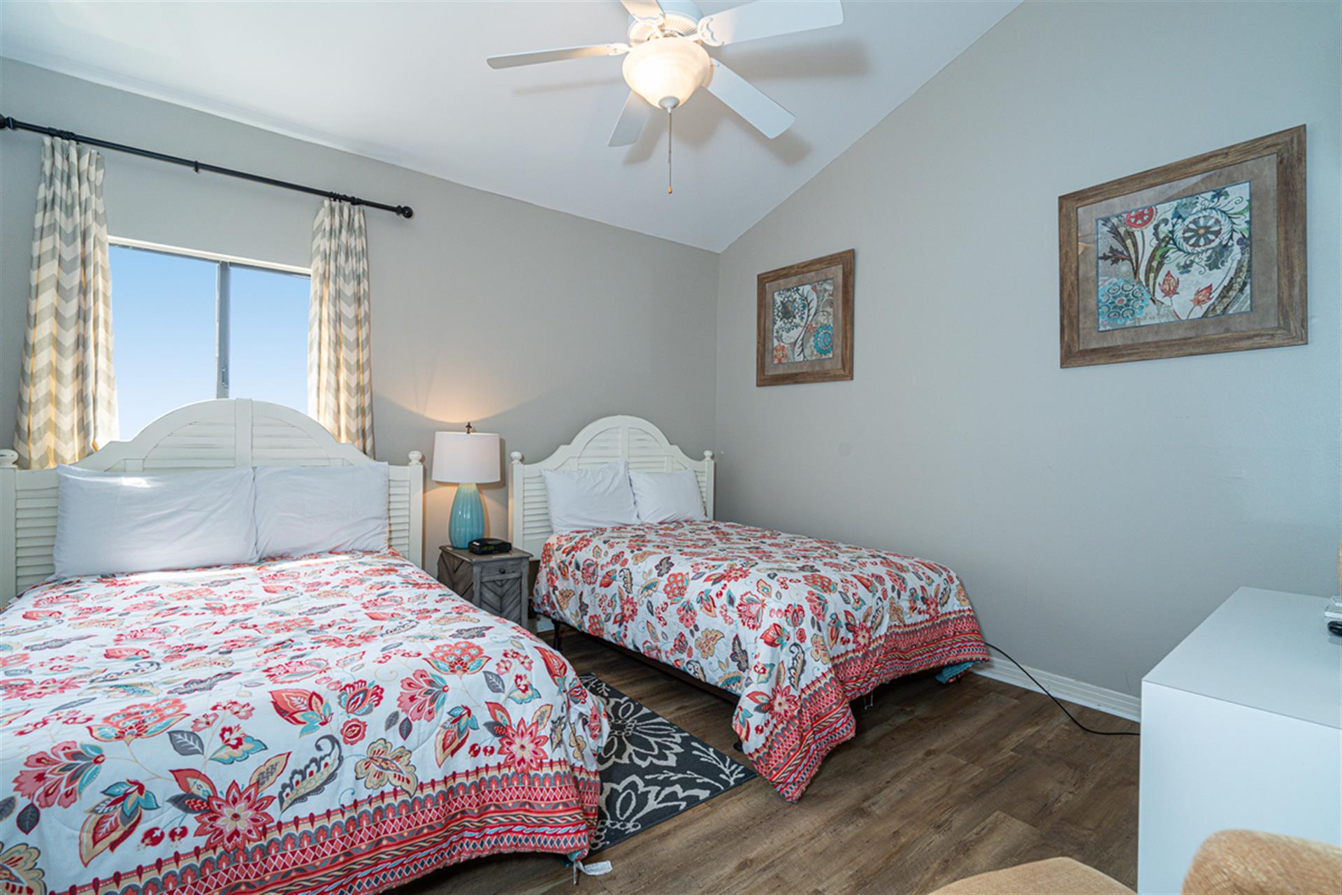 Drift off to sleep in twin beds with cheerful paisley linens, while your ceiling fan keeps you cool and comfortable all night long.