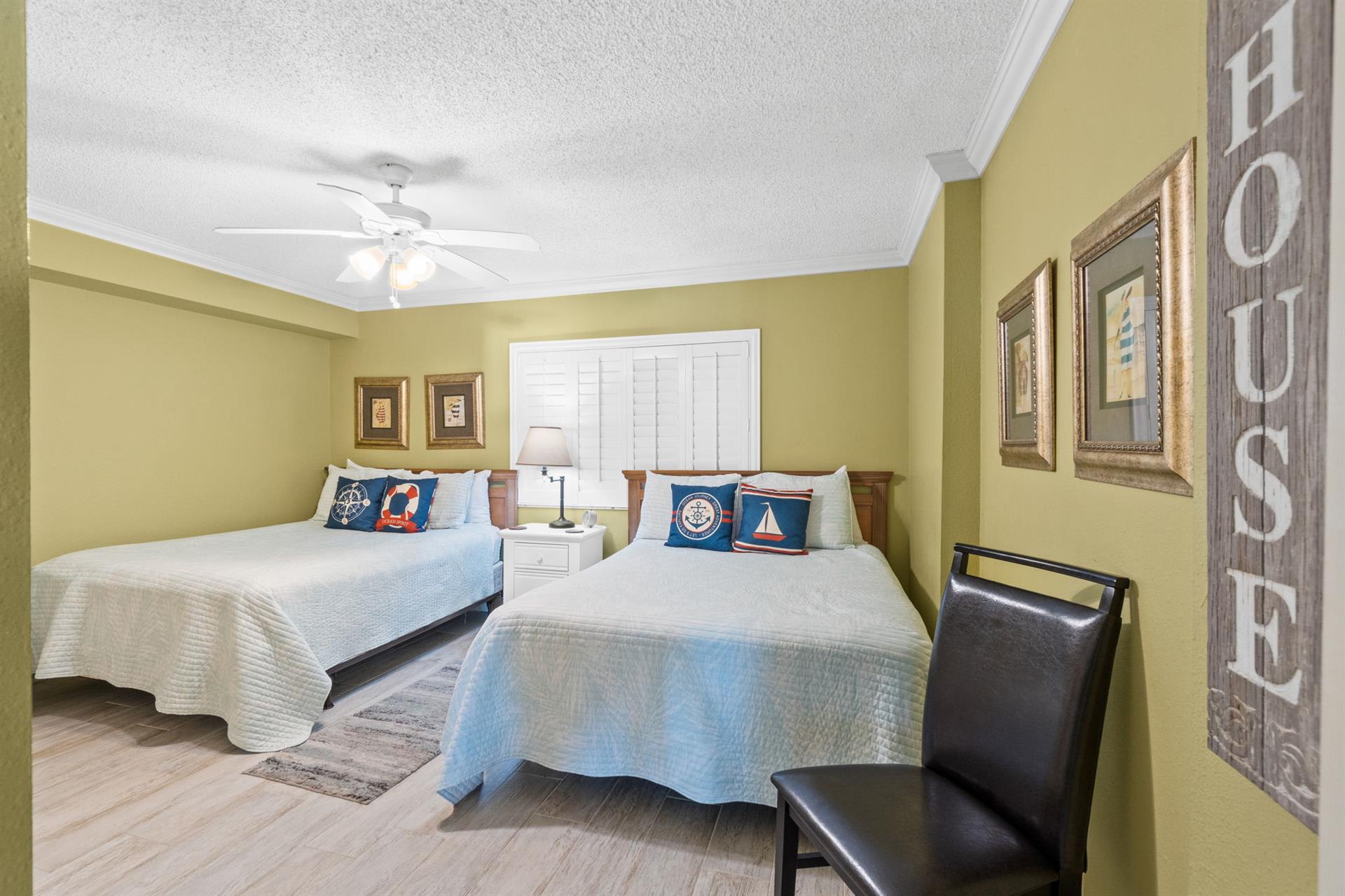 Unwind in this charming twin bedroom with coastal touches and comfortable seating for your seaside getaway.