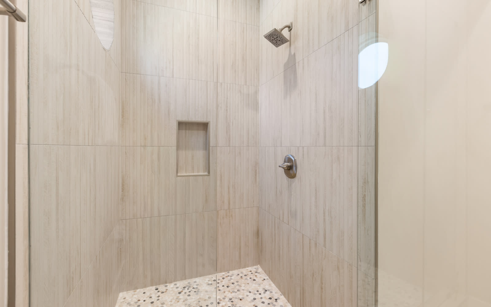 Step into your private oasis with elegant tiled walls and a refreshing rainfall shower to wash away the day.