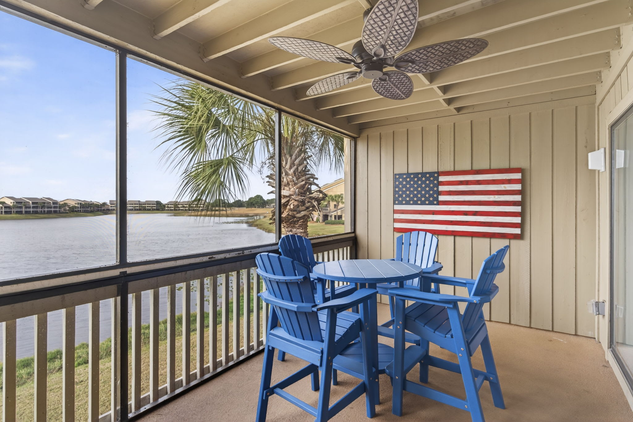 Relax on your private screened balcony with lake views, complete with comfortable dining furniture and a ceiling fan for your comfort.