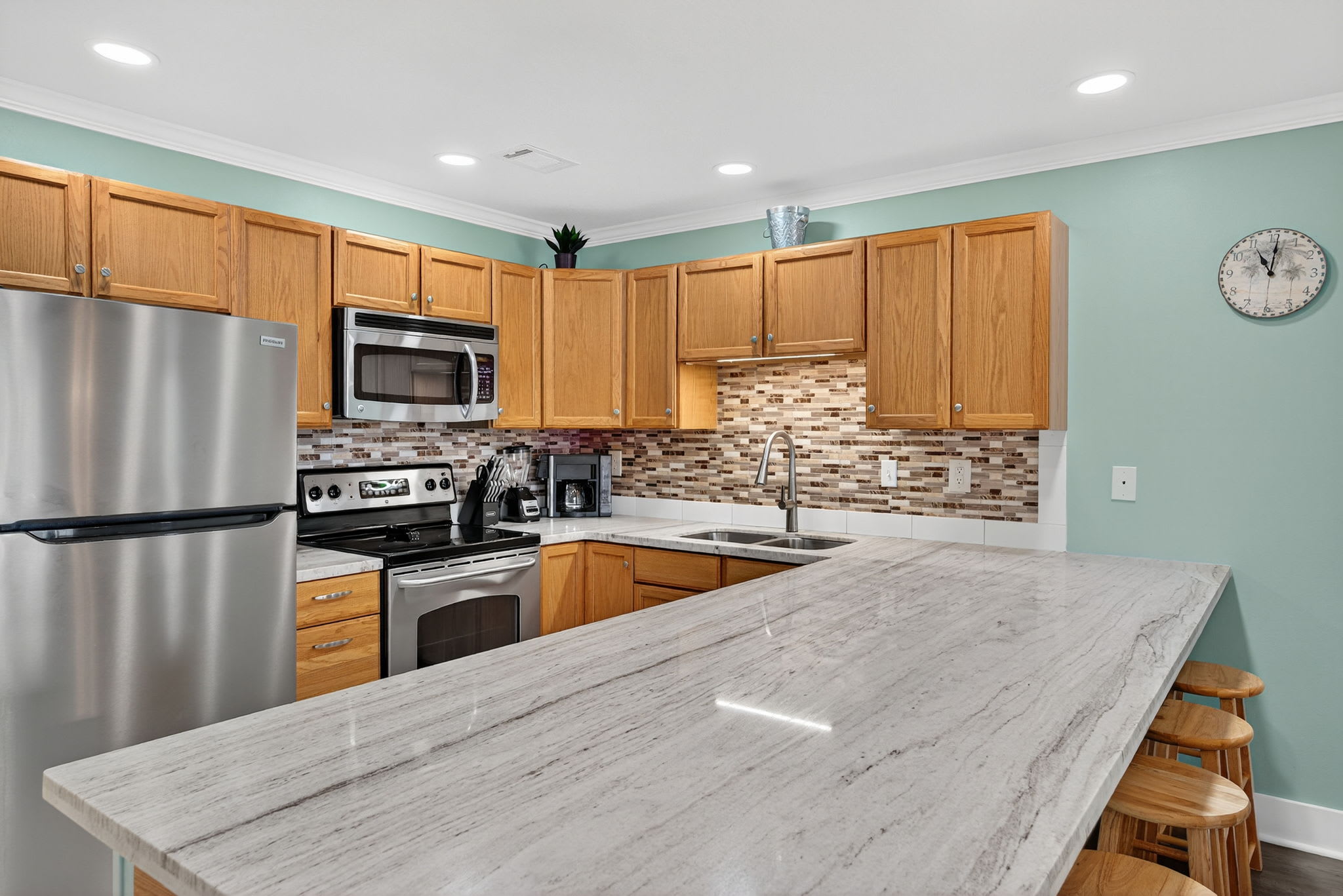Your fully-equipped kitchen features granite countertops, stainless steel appliances, and a convenient breakfast bar where you can enjoy morning coffee or prepare meals together.