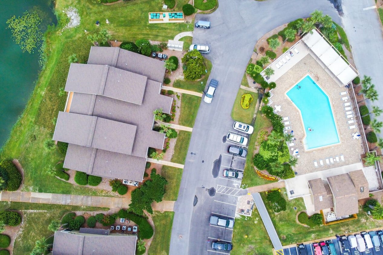Aerial view of the neighborhood. Community pool directly across the parking lot from the unit.