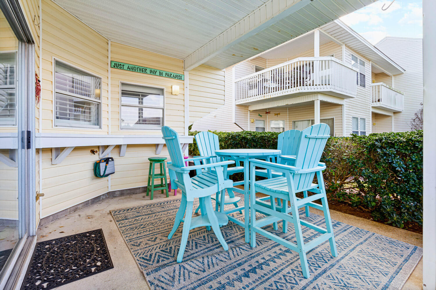 Your charming covered patio features turquoise chairs and table where you can enjoy morning coffee or evening drinks in comfort.
