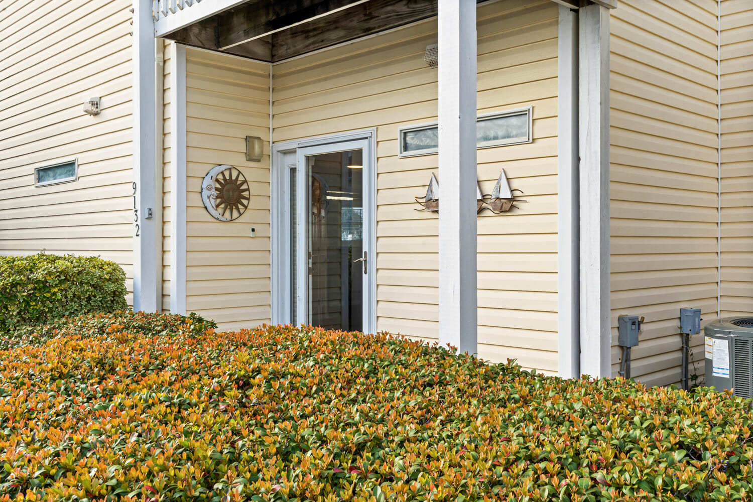A welcoming entrance with charming nautical touches and seasonal foliage creates your perfect coastal retreat arrival.