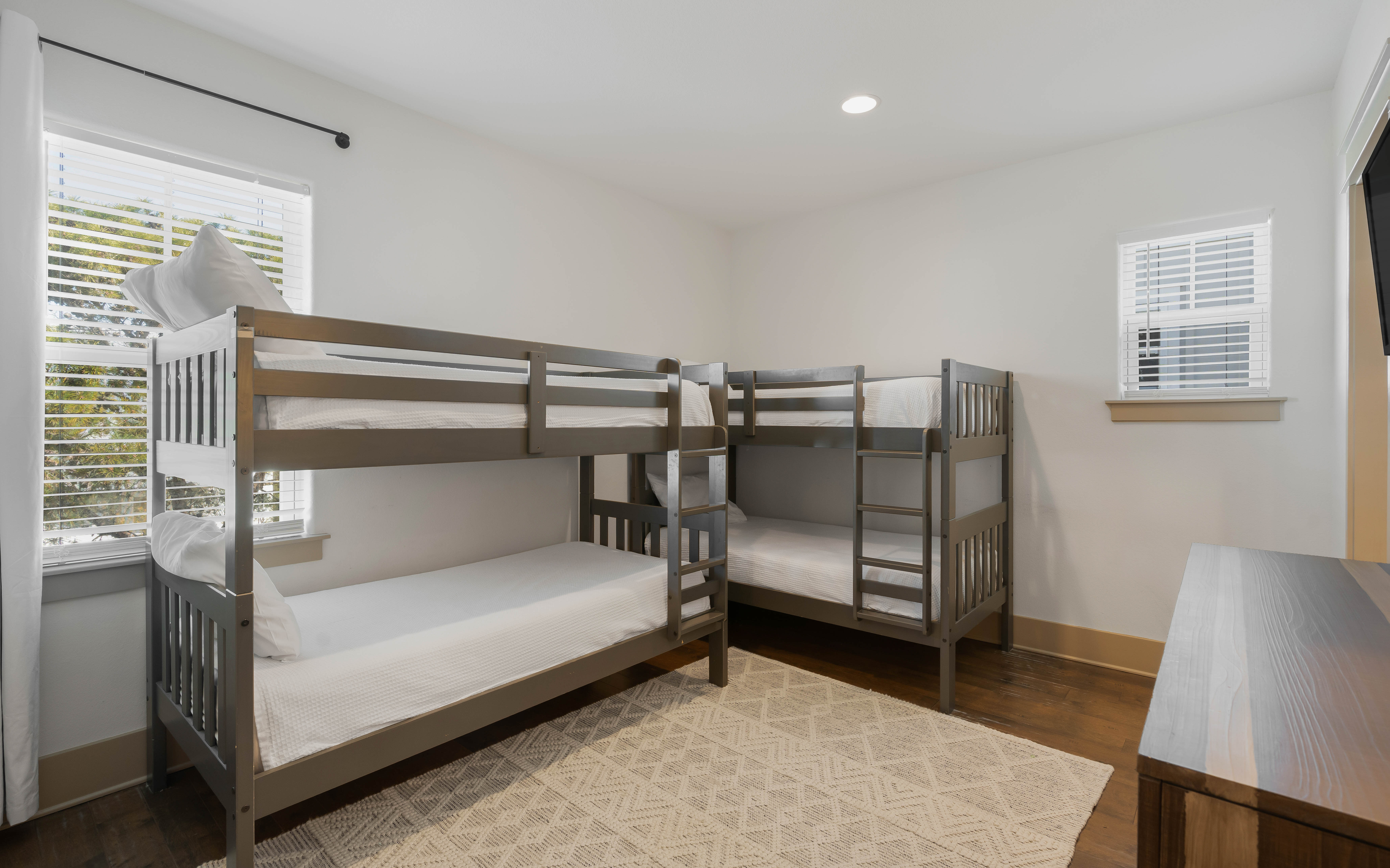 Your kids will love these cozy bunk beds with crisp white linens, perfect for family adventures and bedtime stories.
