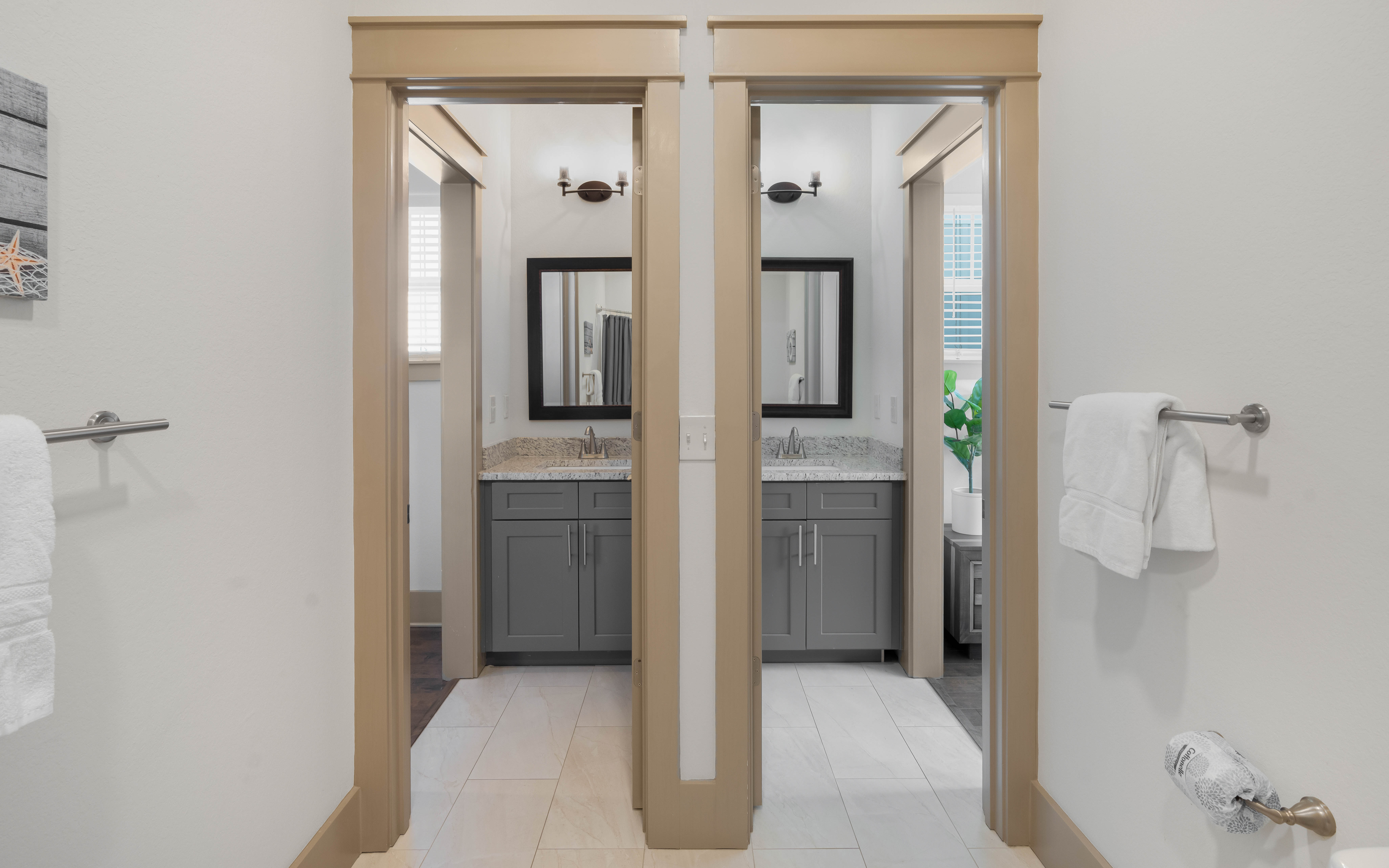 Unwind in your elegantly appointed bathroom featuring dual vanities with granite countertops and modern fixtures.