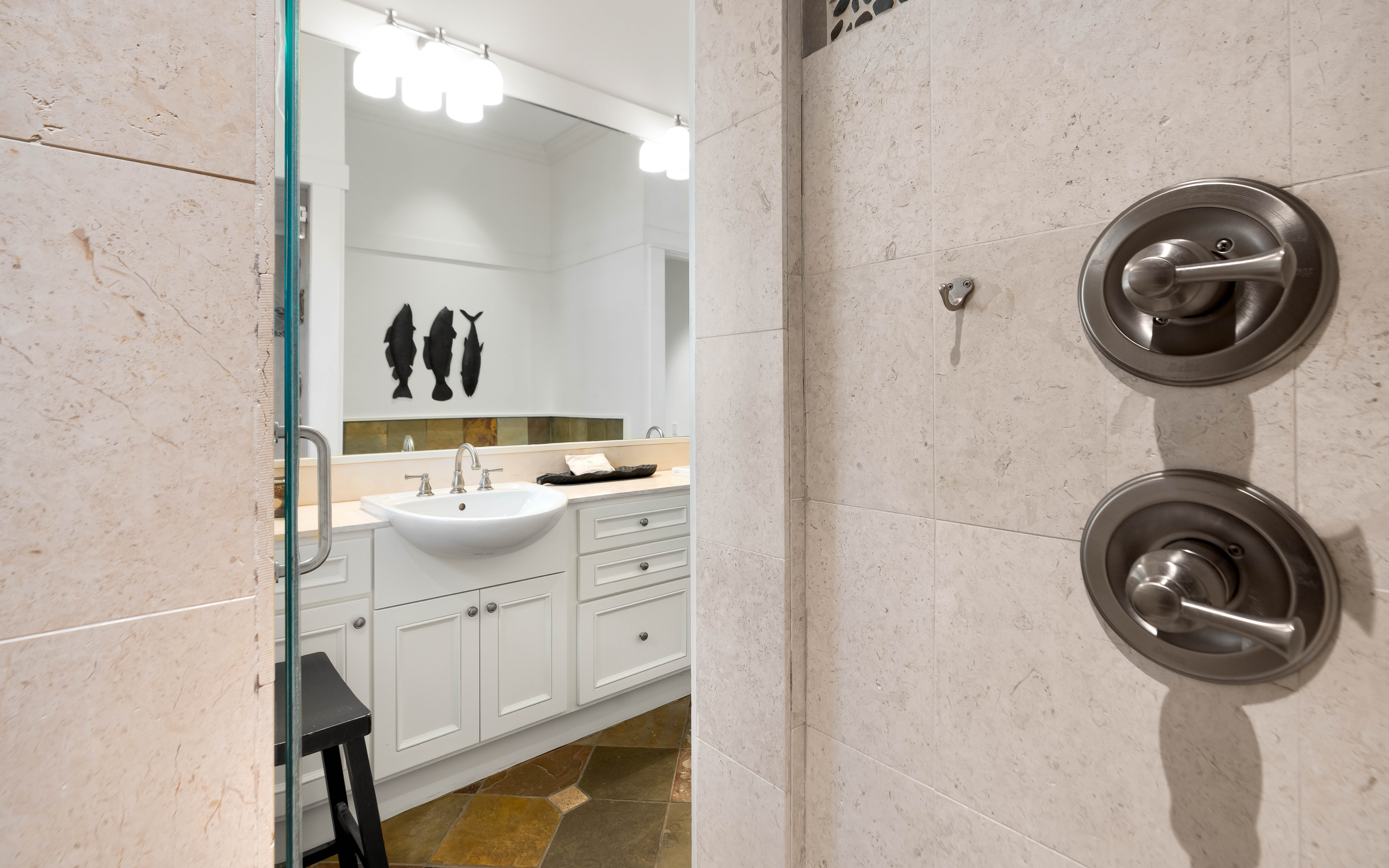 Step into your private spa-like shower with elegant marble walls and modern fixtures, creating the perfect space to refresh after your adventures.