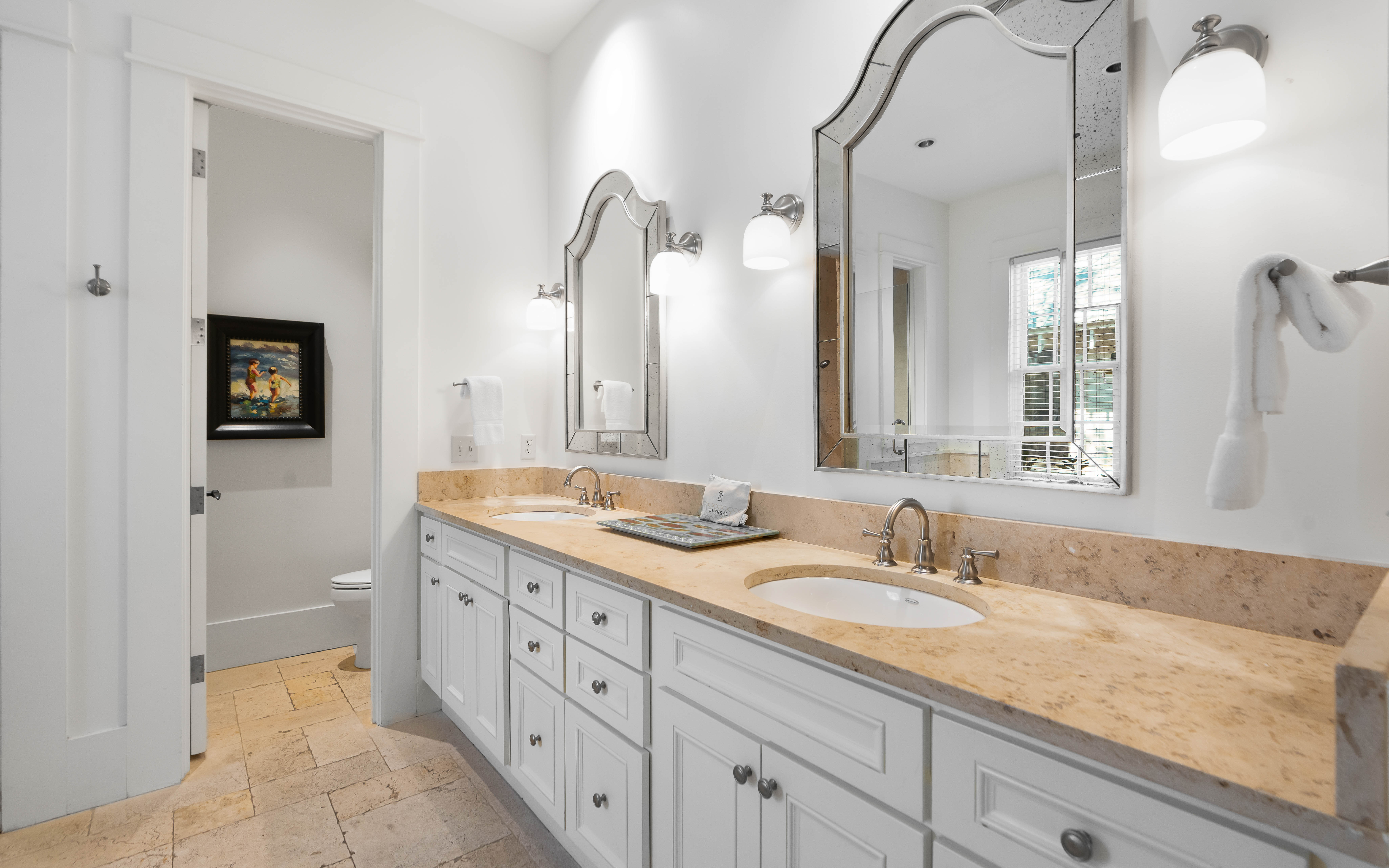 Pamper yourself at this elegant double vanity with marble countertops, perfect lighting, and spa-like amenities for your morning routine.