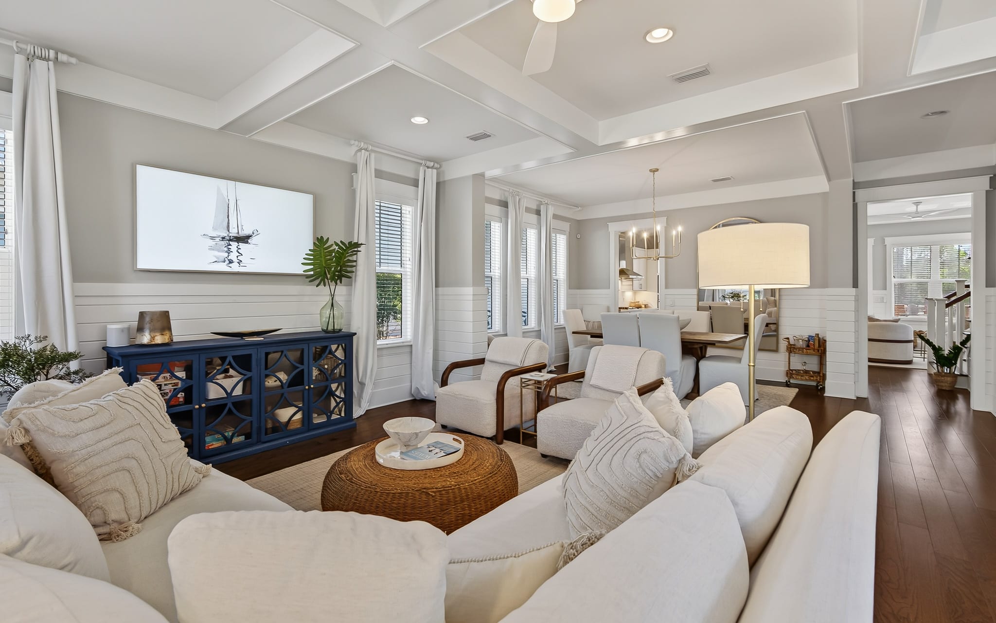 Unwind in your elegant living space with plush seating, coffered ceilings, and coastal charm that creates the perfect retreat.