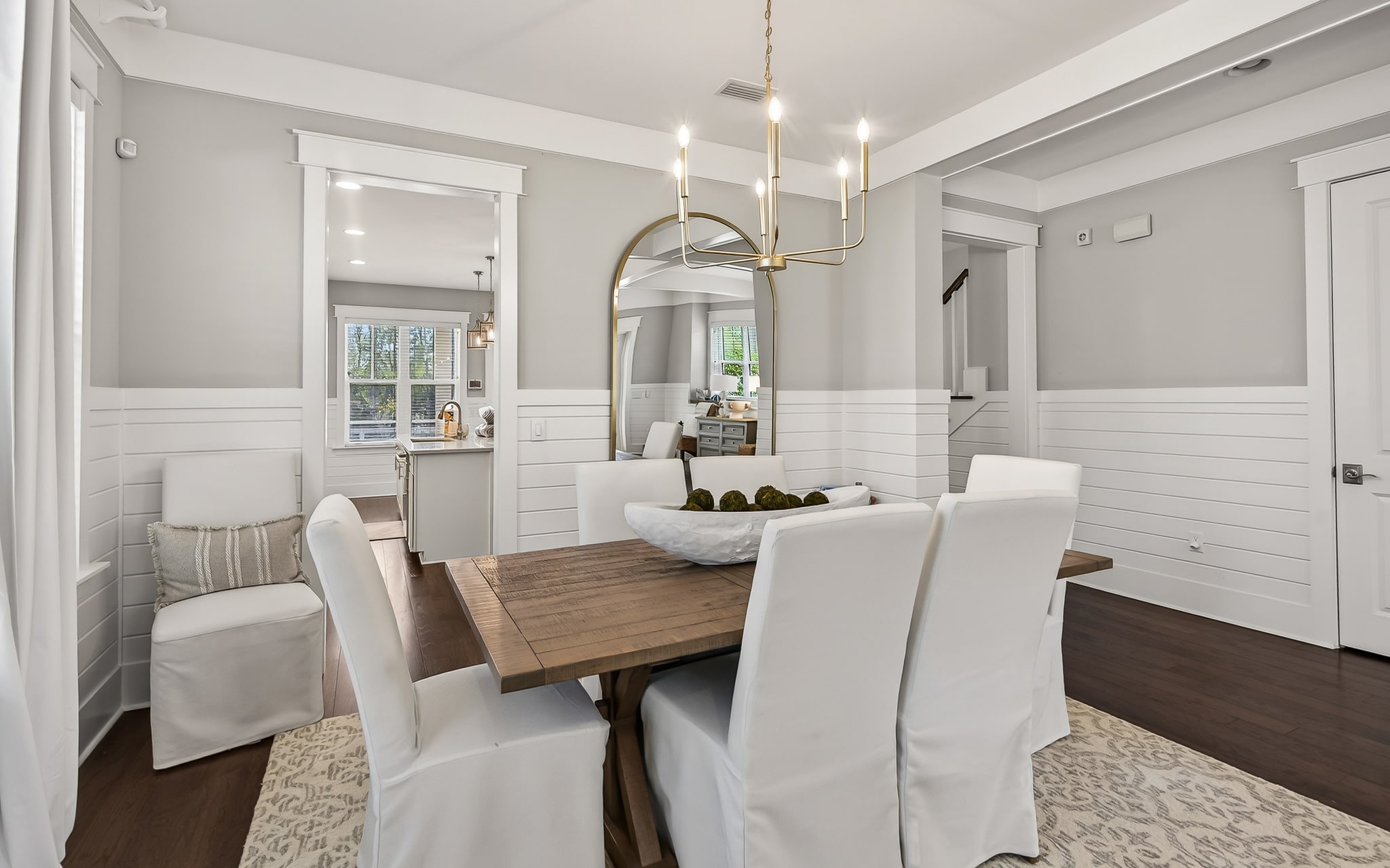 Step into your elegant dining space where warm wood meets crisp white details, perfect for memorable meals together.