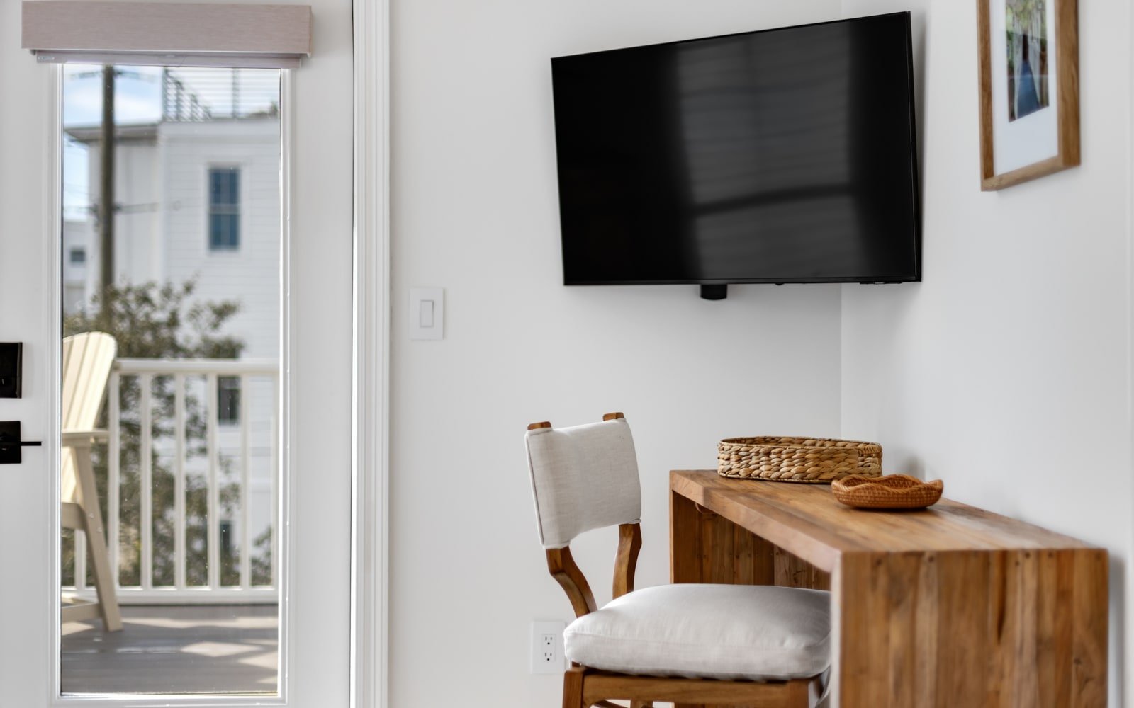 Relax in this bright living space with modern TV and warm wood accents, plus your own private balcony for morning coffee.