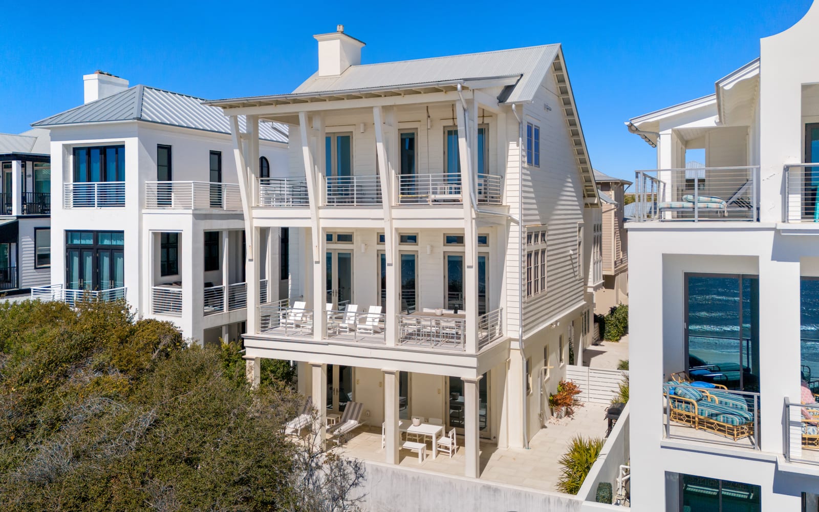 Stunning coastal architecture features multiple levels of covered porches and modern balconies in this beachside neighborhood.