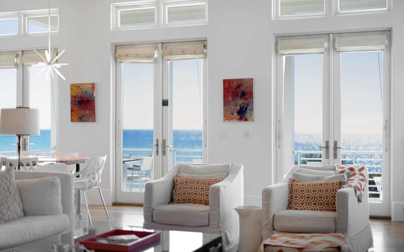 Relax in this bright living space where floor-to-ceiling windows frame stunning ocean views and modern comfort awaits.