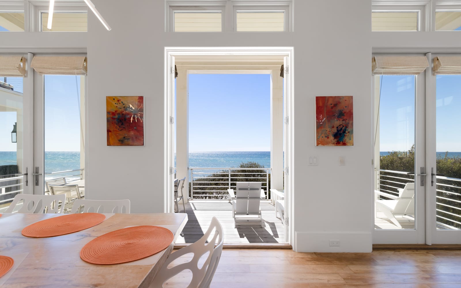 Your bright dining space opens to stunning ocean views through floor-to-ceiling doors, creating perfect indoor-outdoor flow.