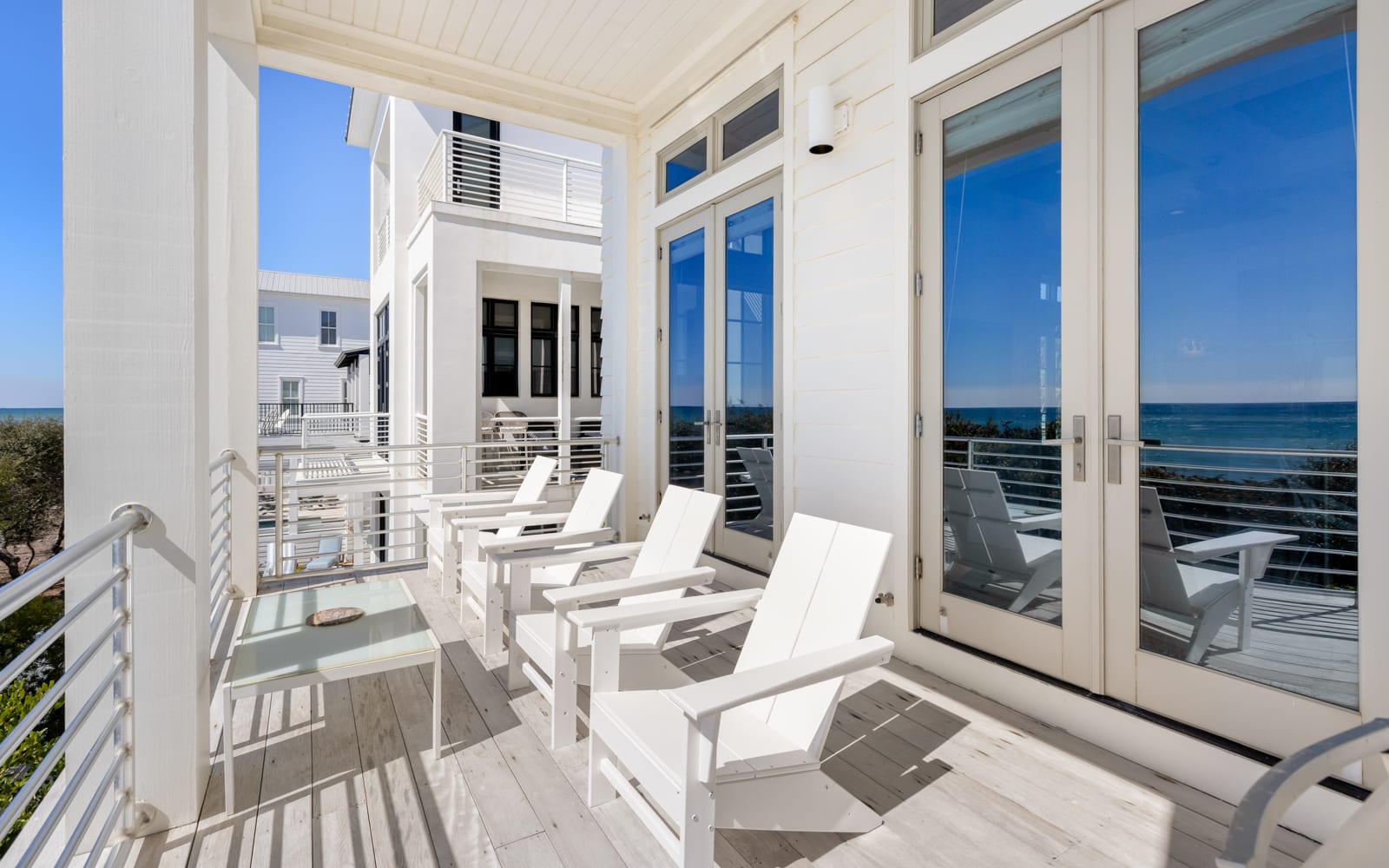 Unwind on your private balcony with ocean views, where white loungers invite you to soak up coastal breezes.