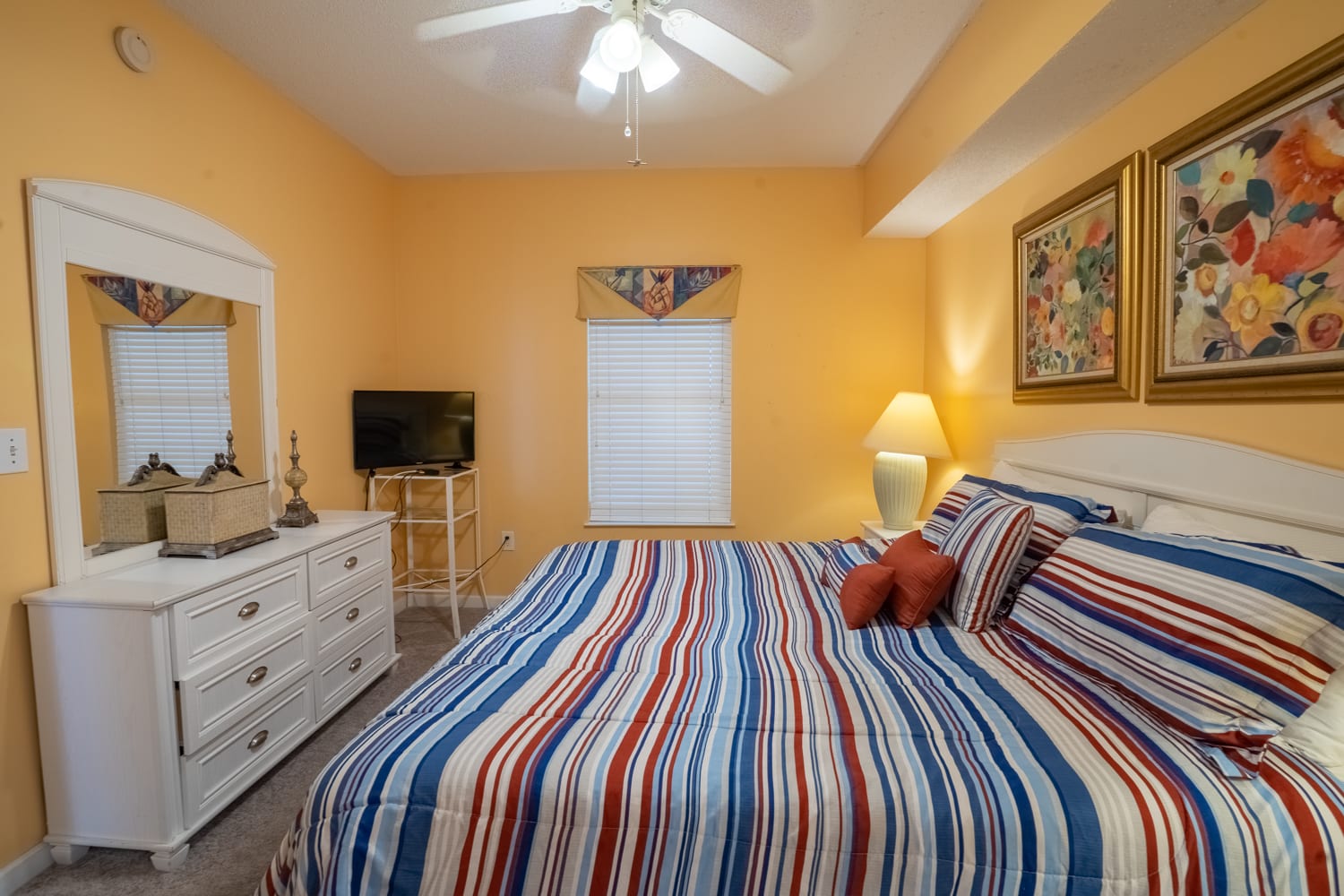 Primary bedroom with flatscreen television.