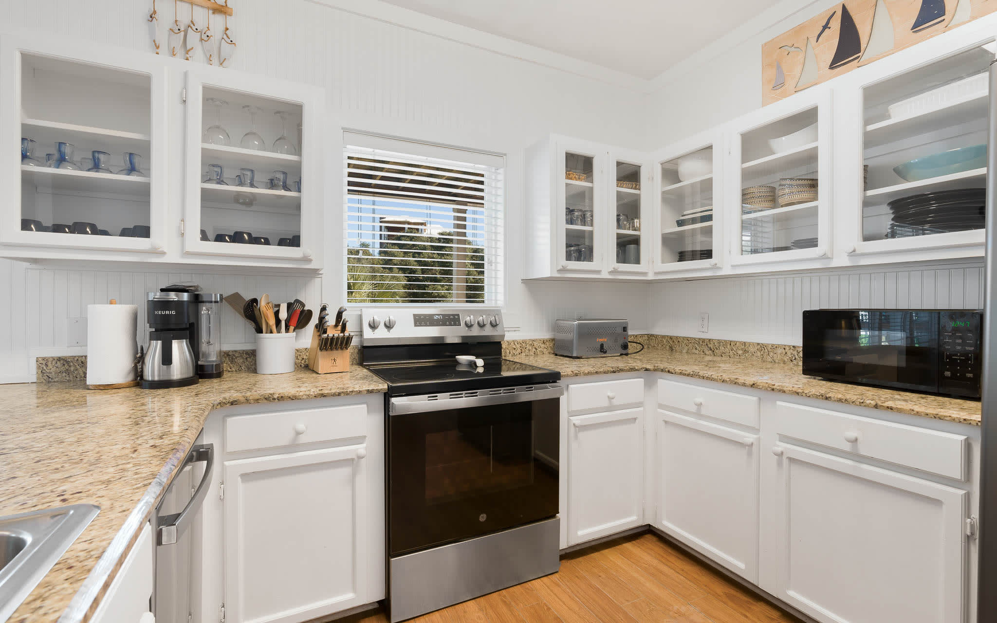 Your fully equipped kitchen features granite counters, glass-front cabinets, and everything needed to create memorable meals during your stay.