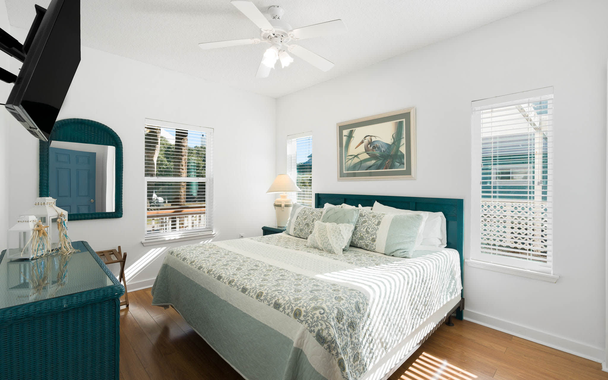 Step into your serene coastal bedroom where calming teal tones and natural light create the perfect retreat for peaceful nights.