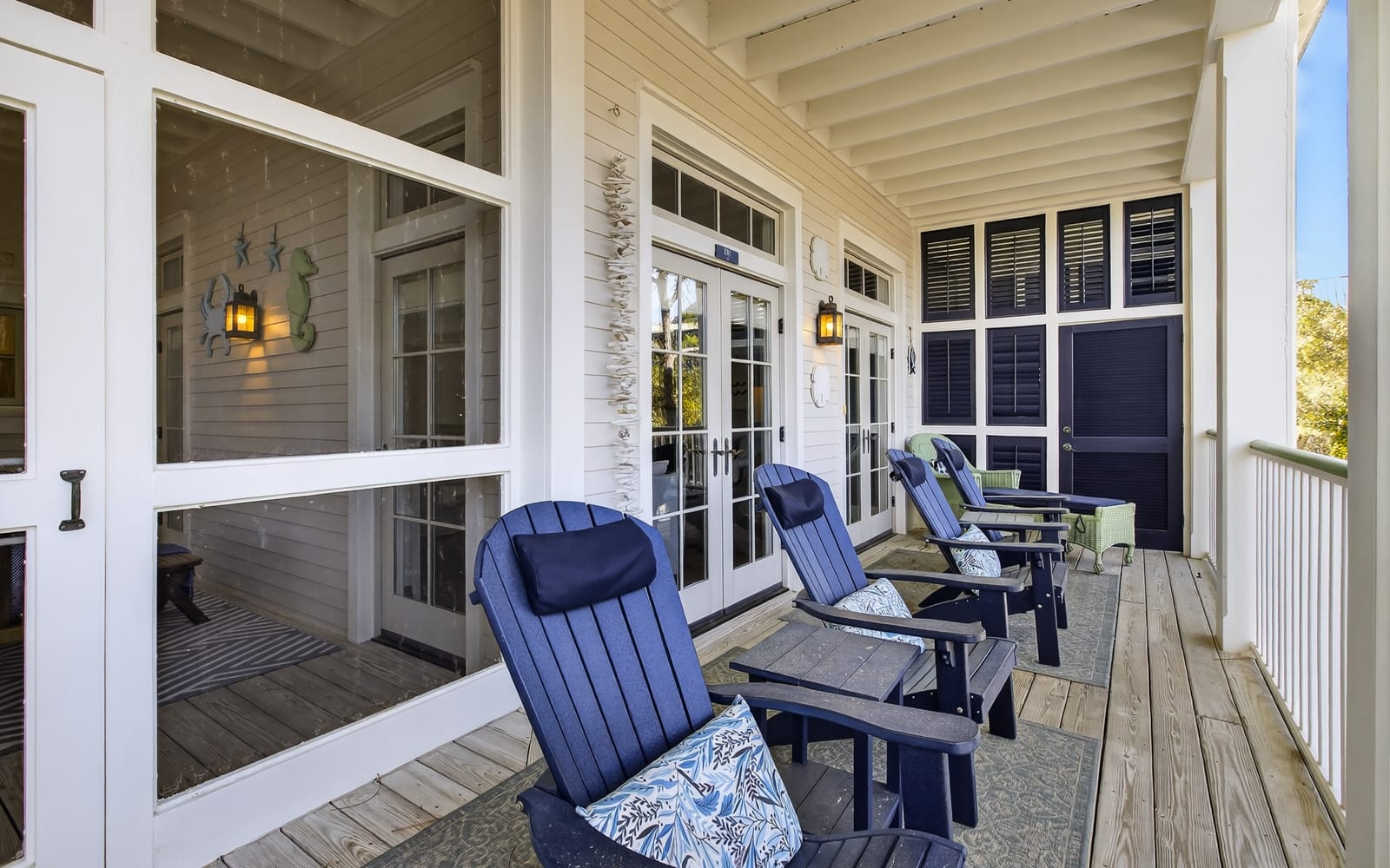 Unwind on your private covered porch with comfortable navy Adirondack chairs, perfect for morning coffee or evening relaxation.