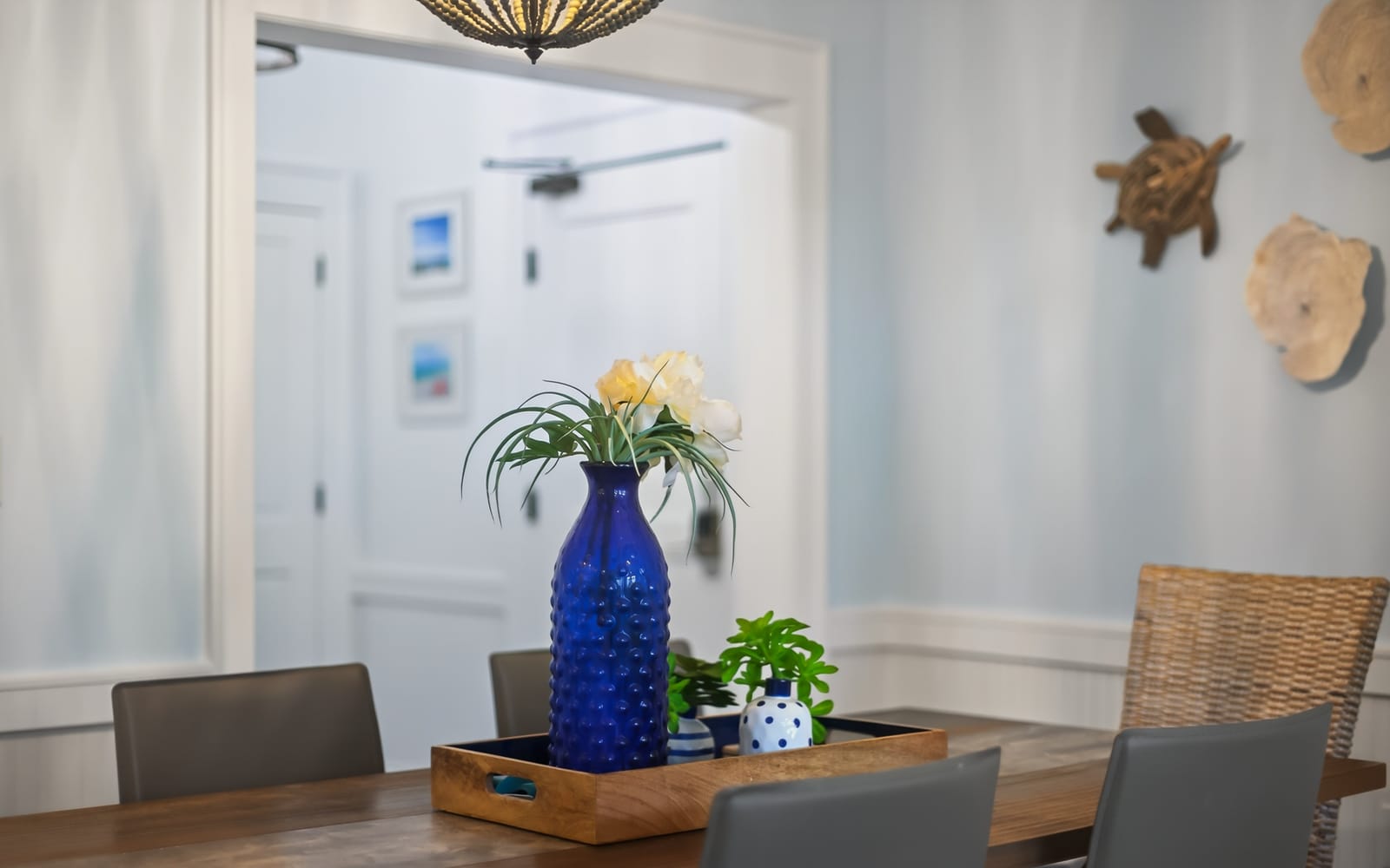 Your dining space welcomes you with coastal charm—fresh flowers and nautical touches create the perfect setting for memorable meals together.