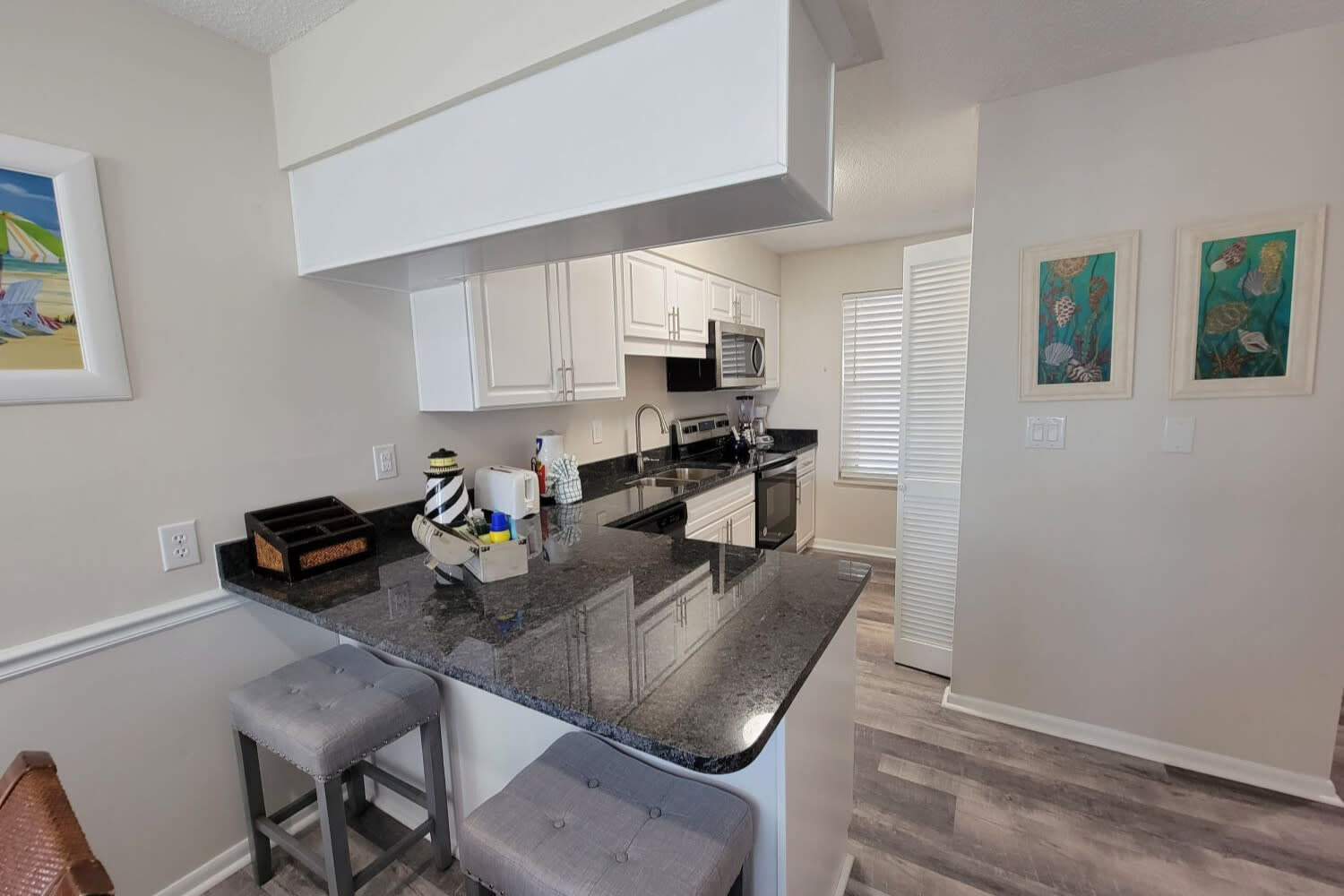 Kitchen area with seating for two (2) at the bar.