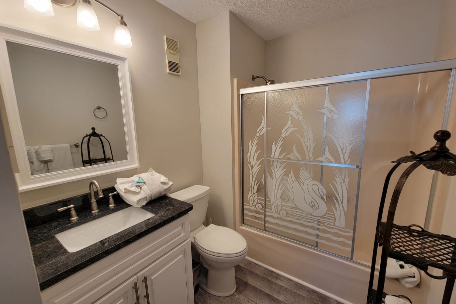 Primary bathroom with tub and shower combination.