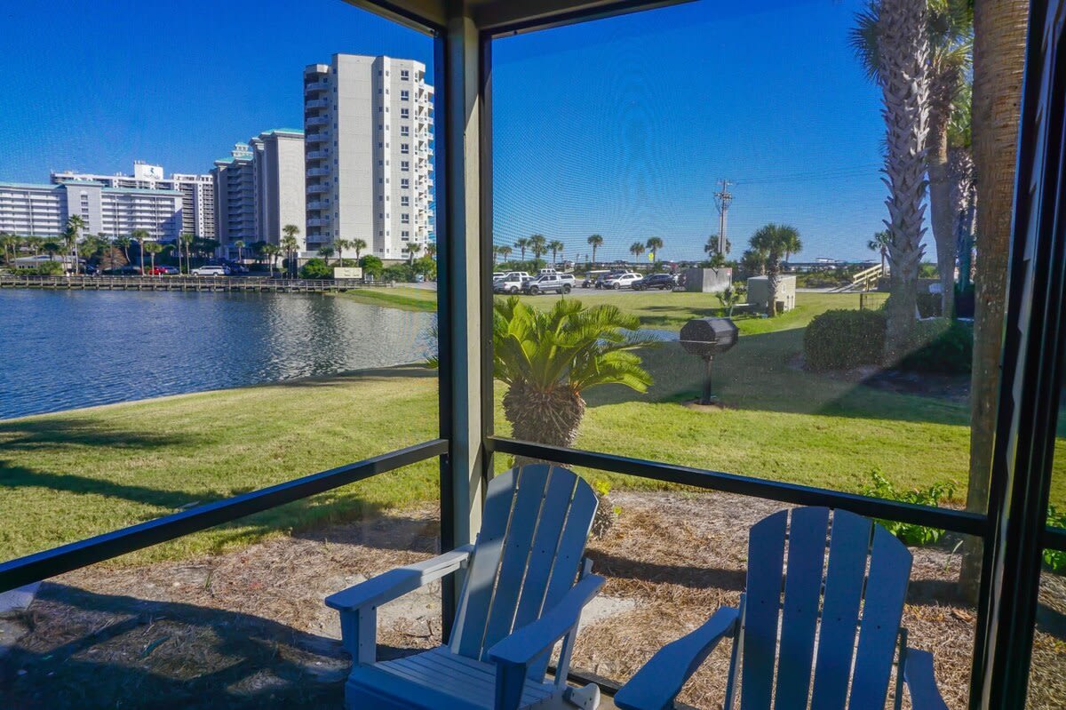 Relax on the screened patio with Adirondack chairs and enjoy peaceful lake views, swaying palms, and a glimpse of the Gulf just beyond. A perfect spot for morning coffee or evening sunsets.
