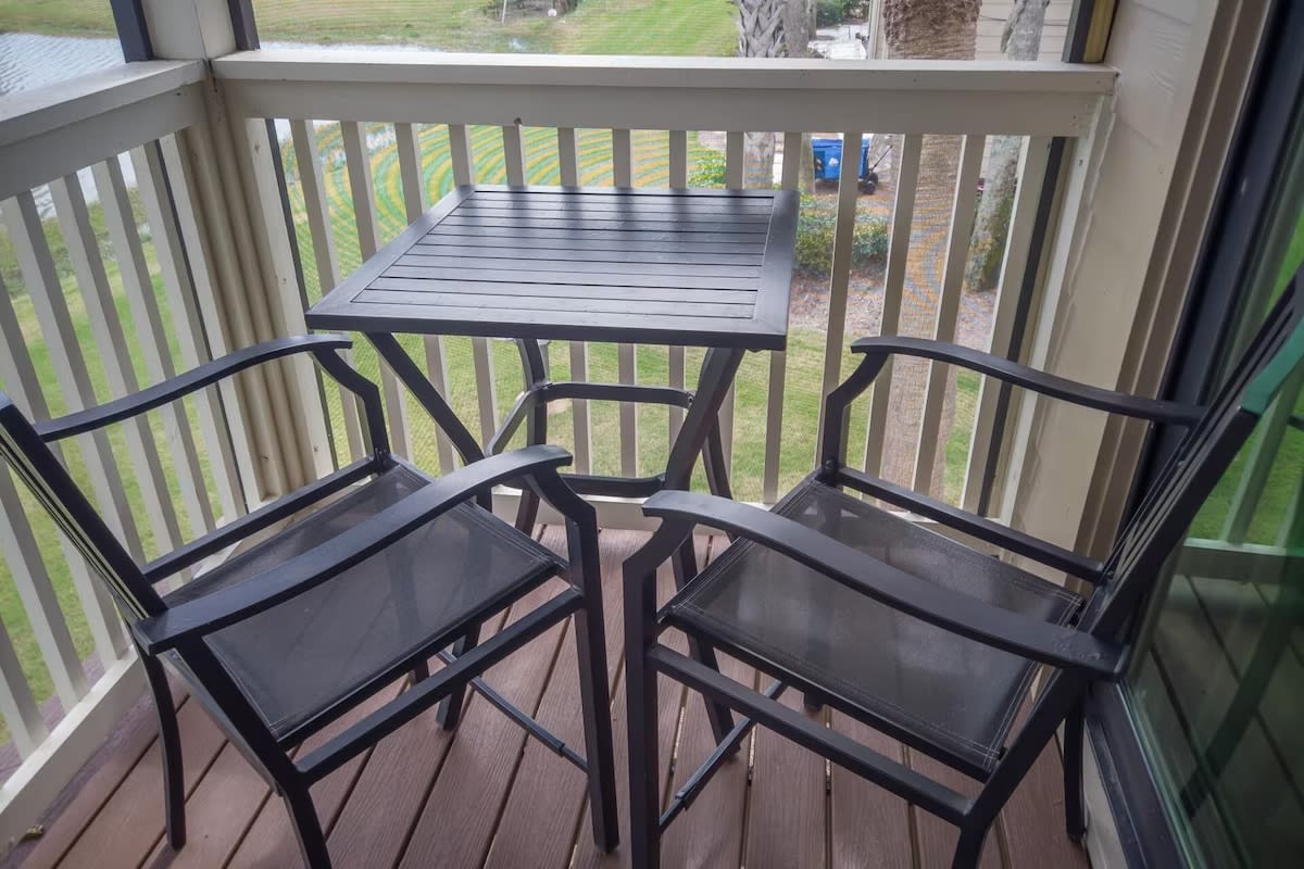 Private balcony with a bistro table and high-top chairs—perfect for sipping morning coffee or enjoying a peaceful evening breeze with a view.