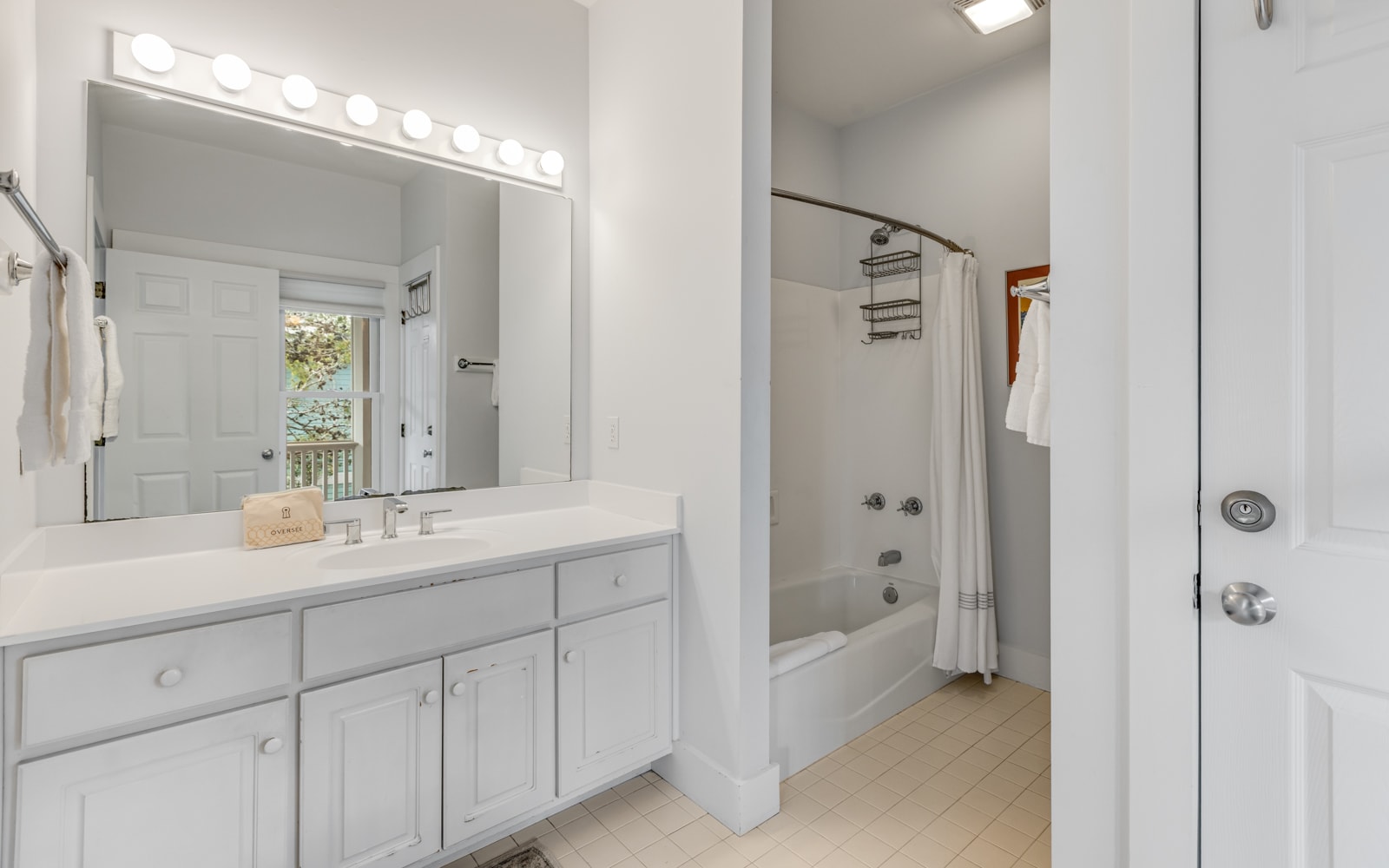 Your bright bathroom features a spacious vanity with Hollywood-style lighting, perfect for getting ready each morning.