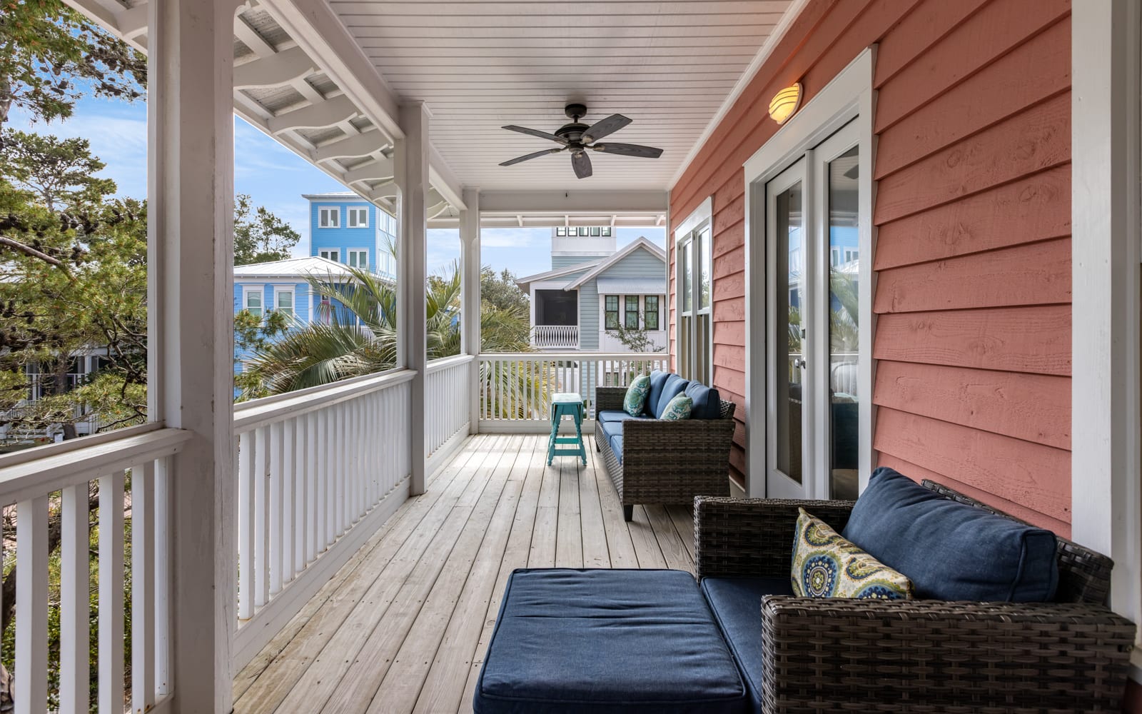 Relax on your private covered porch with comfortable seating and ceiling fan, where coastal breezes and neighborhood views create the perfect retreat.