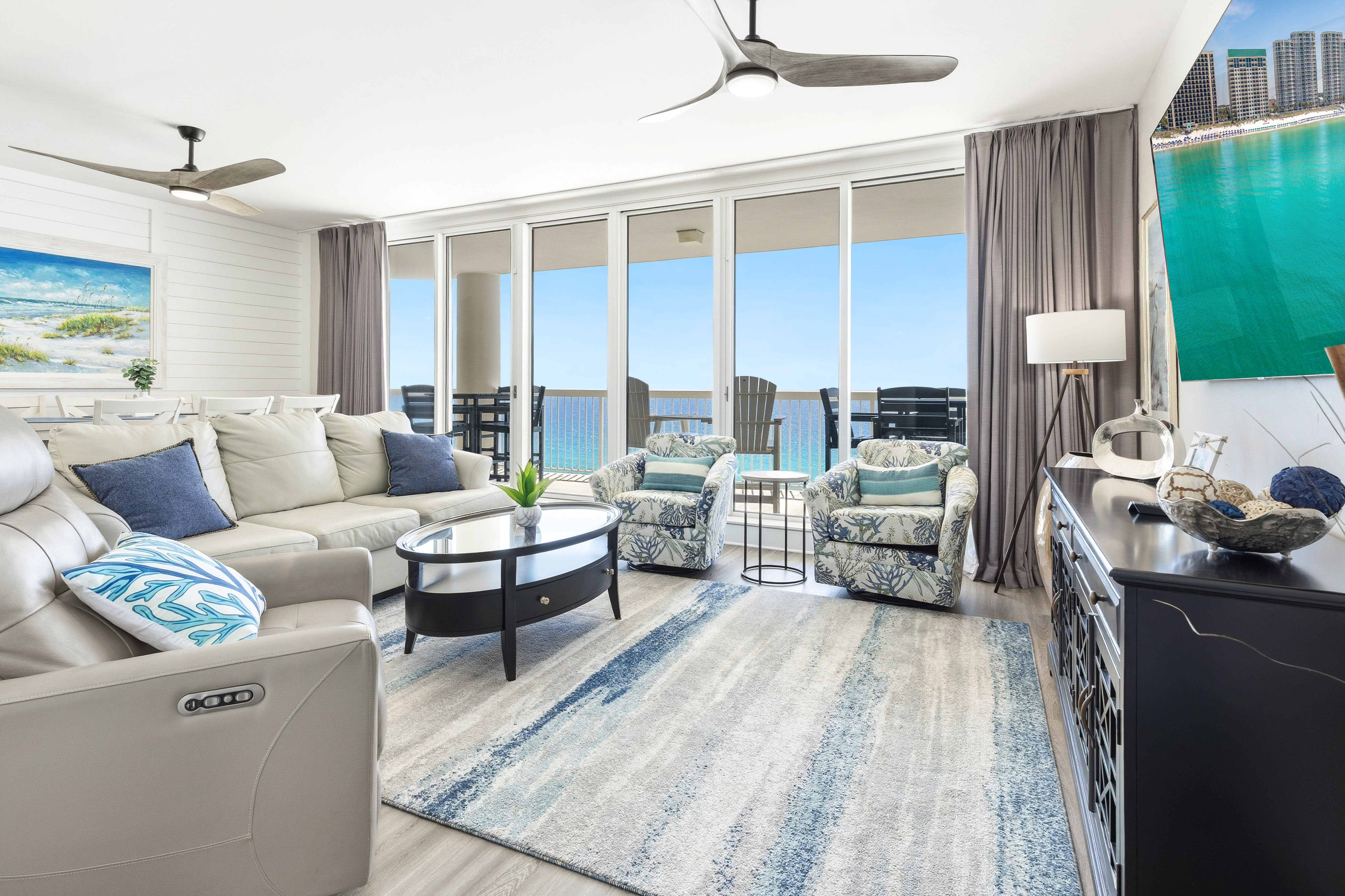 Sink into plush seating while soaking up breathtaking ocean views from your private balcony in this bright, airy living space.