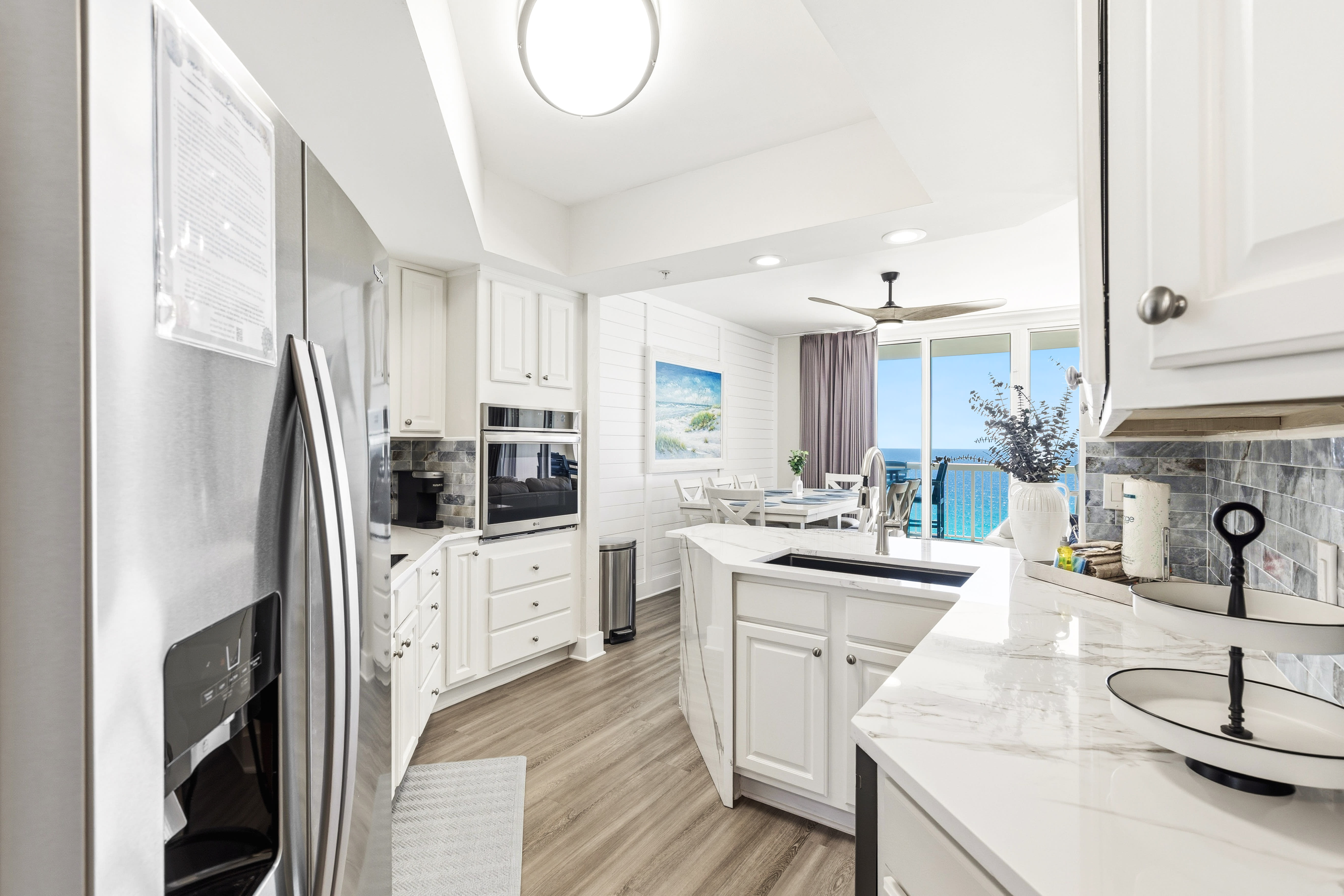Cook with ocean views through your bright kitchen windows, featuring modern appliances and elegant marble countertops.