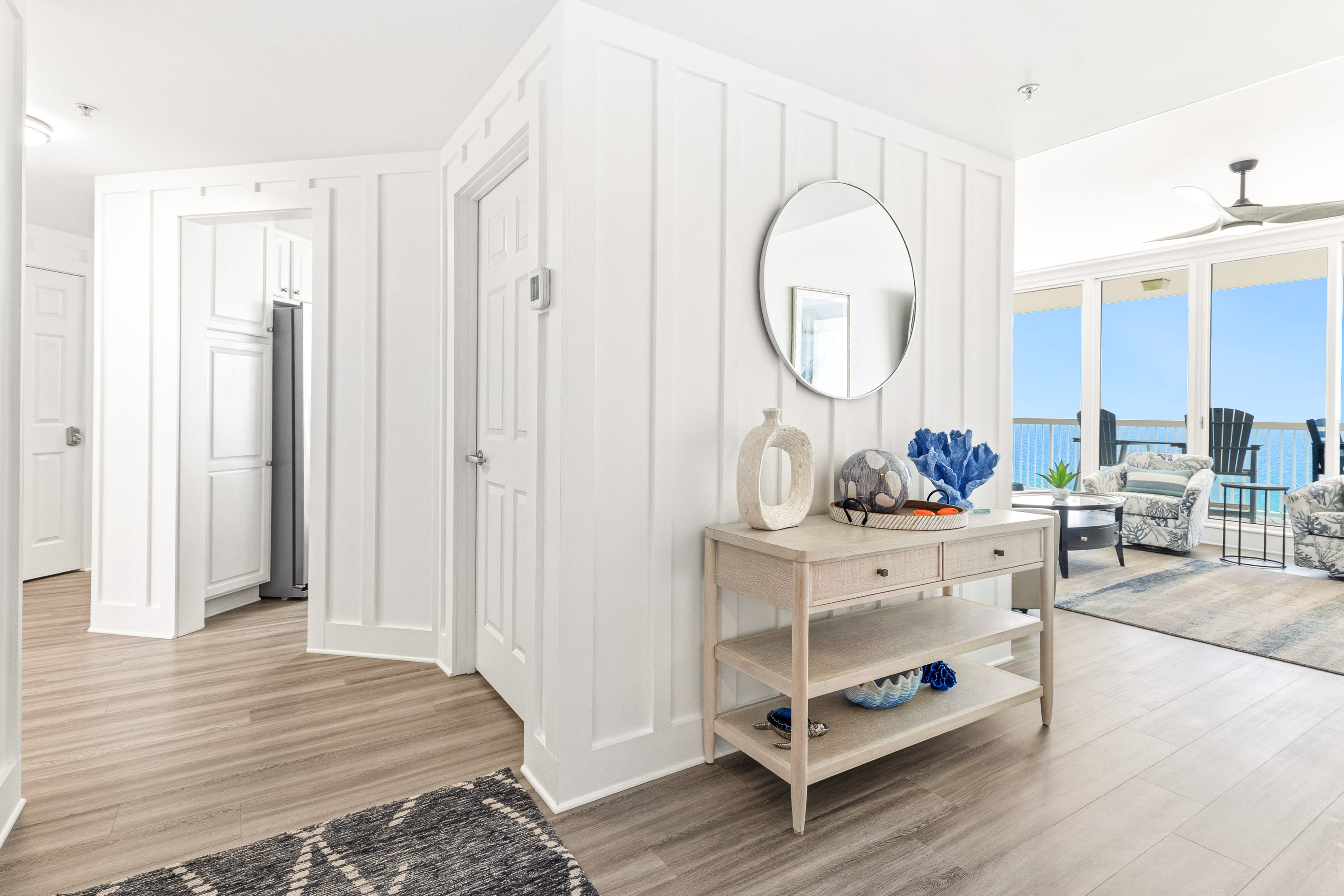 Step into your bright coastal retreat where ocean views greet you through floor-to-ceiling windows and coastal décor creates instant relaxation.