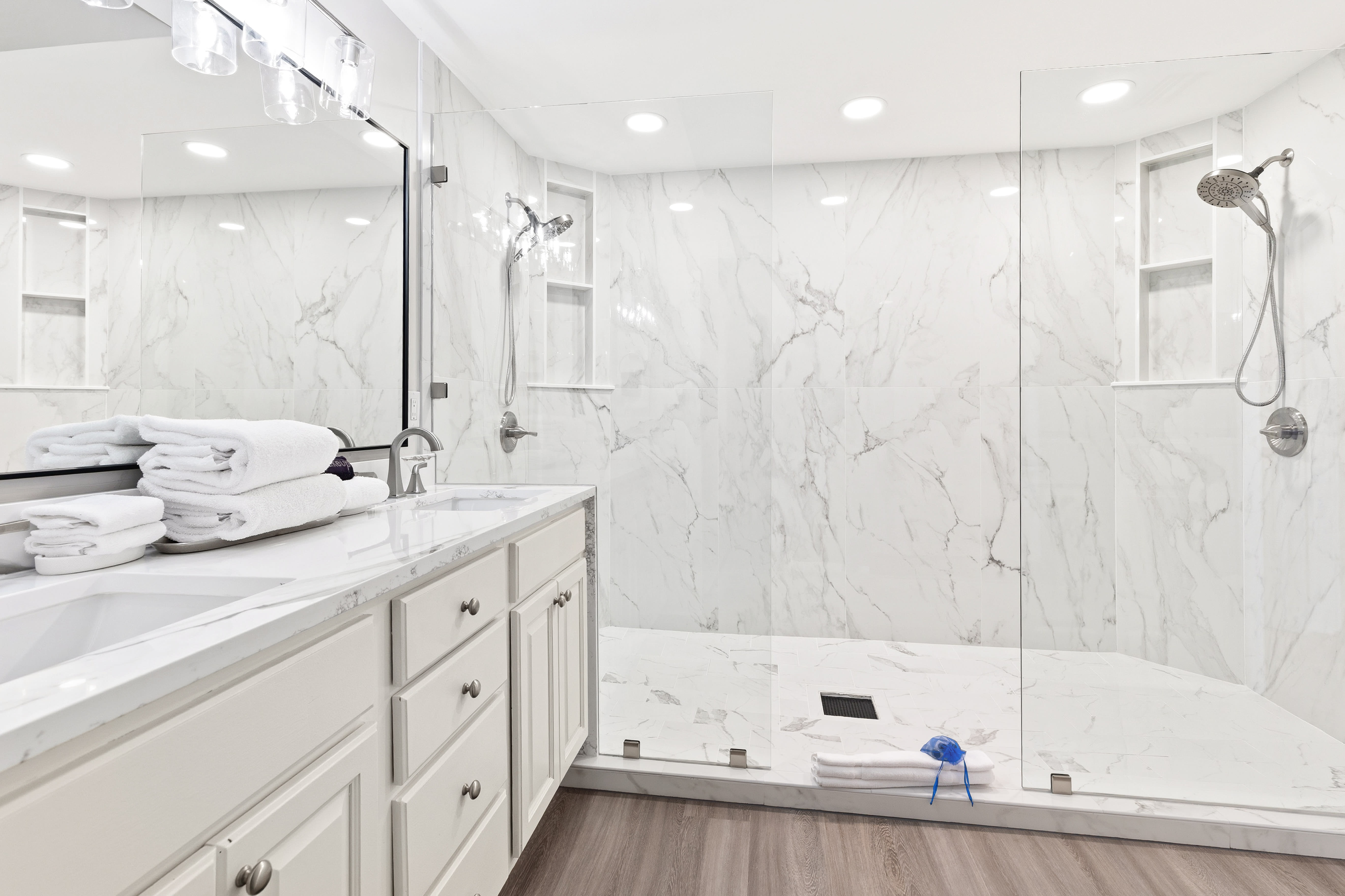 Luxurious marble bathroom featuring a spacious walk-in shower and soaking tub, where you can unwind in sophisticated comfort.