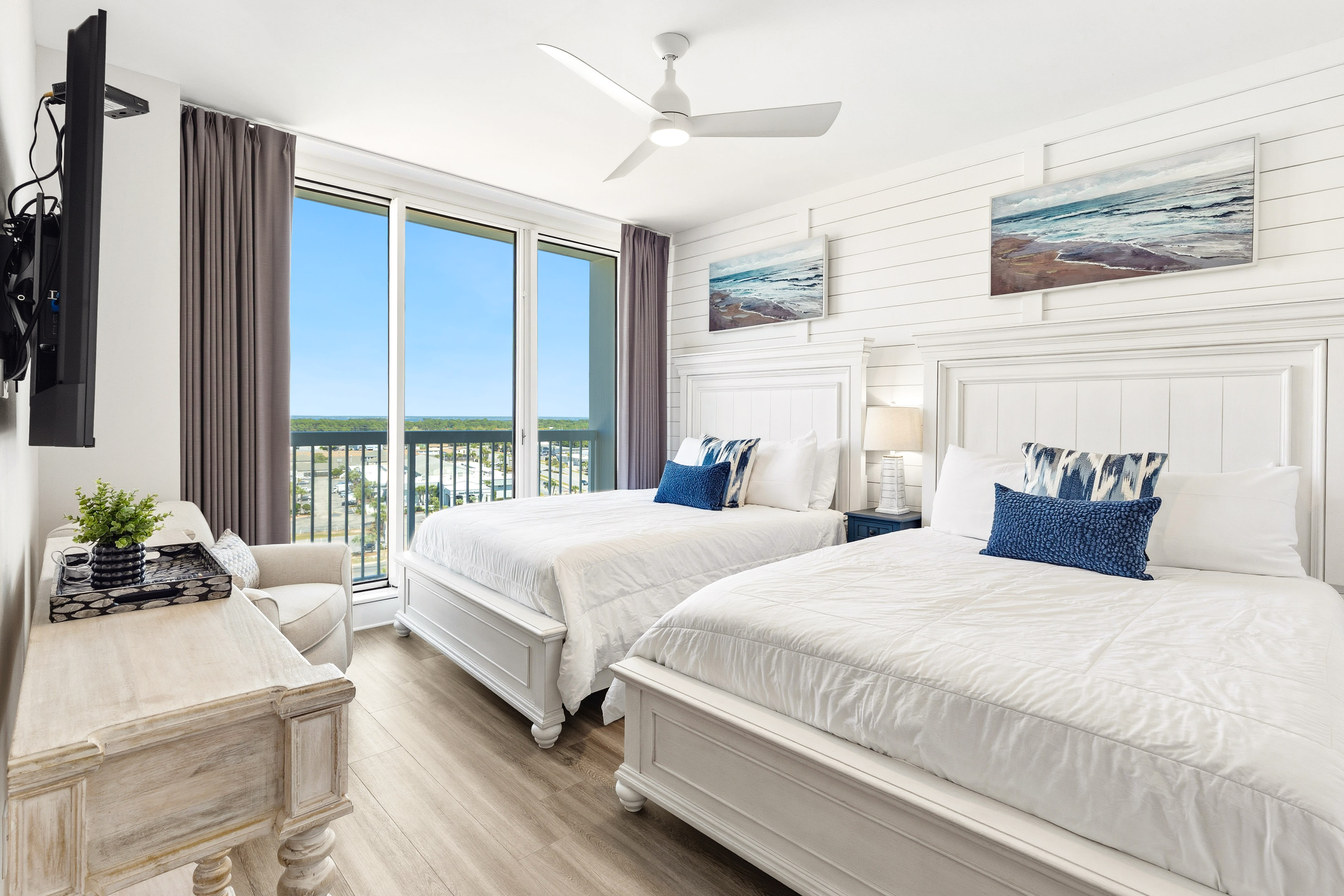 Drift off to sleep in your coastal-themed bedroom with two plush beds and stunning views through floor-to-ceiling windows.