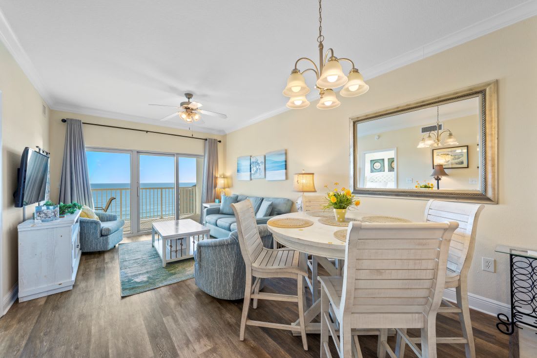 Your beachfront living room invites relaxation with ocean views, comfortable seating, and coastal décor that perfectly frames your seaside escape.