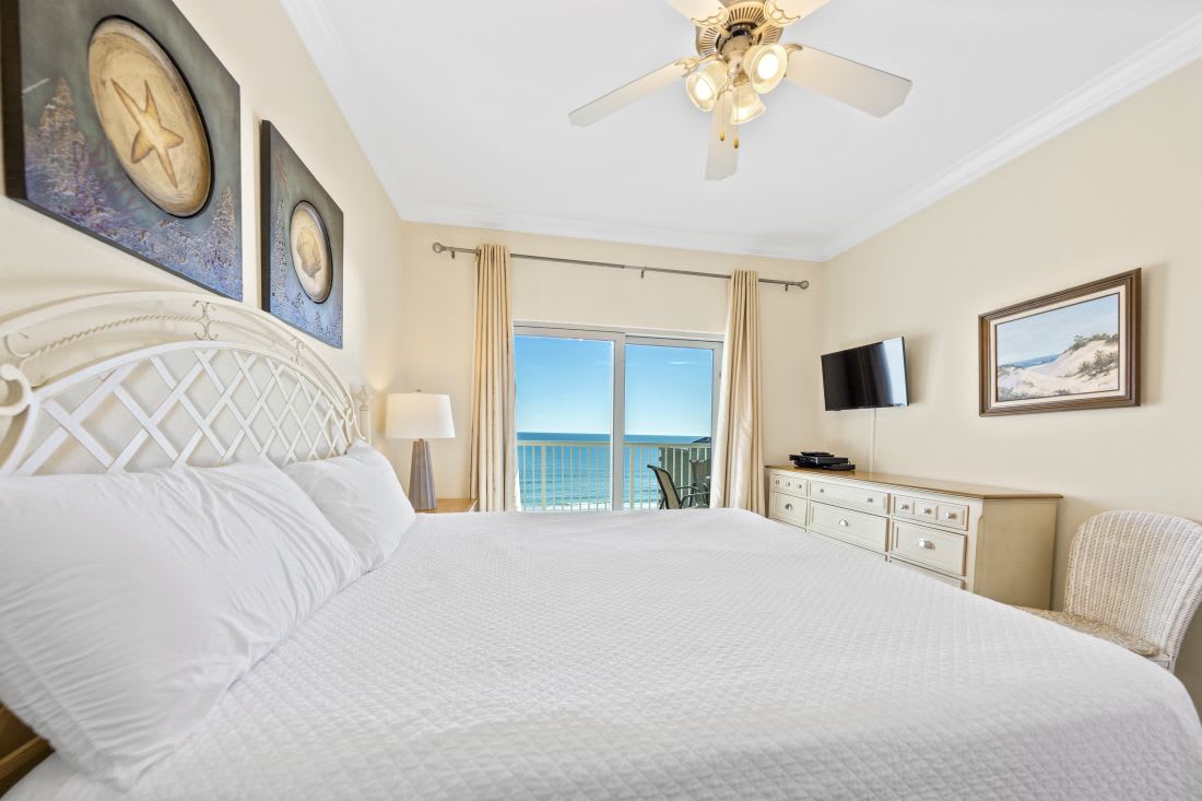 Wake up to endless ocean views from your plush king bed, where morning light dances across crisp white linens and coastal décor.