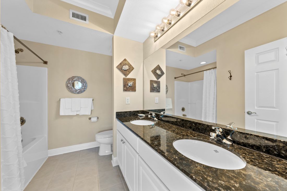 Pamper yourself in this elegant bathroom featuring granite countertops, dual sinks, and a relaxing soaking tub perfect for unwinding after your adventures.