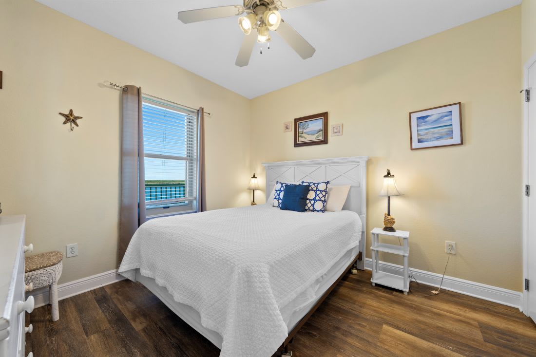 Drift off in this cozy bedroom with soft linens, warm lighting, and charming coastal touches that make you feel right at home.