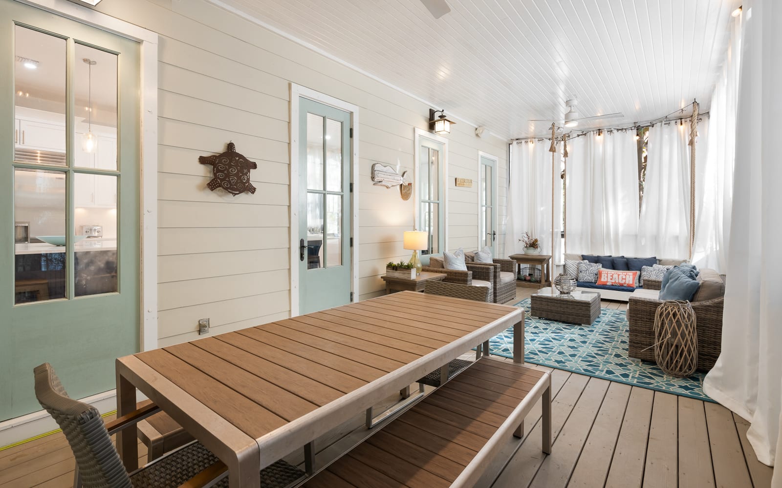 Relax in your private coastal screened porch with nautical charm, comfortable seating, and peaceful outdoor dining perfect for morning coffee or sunset meals.