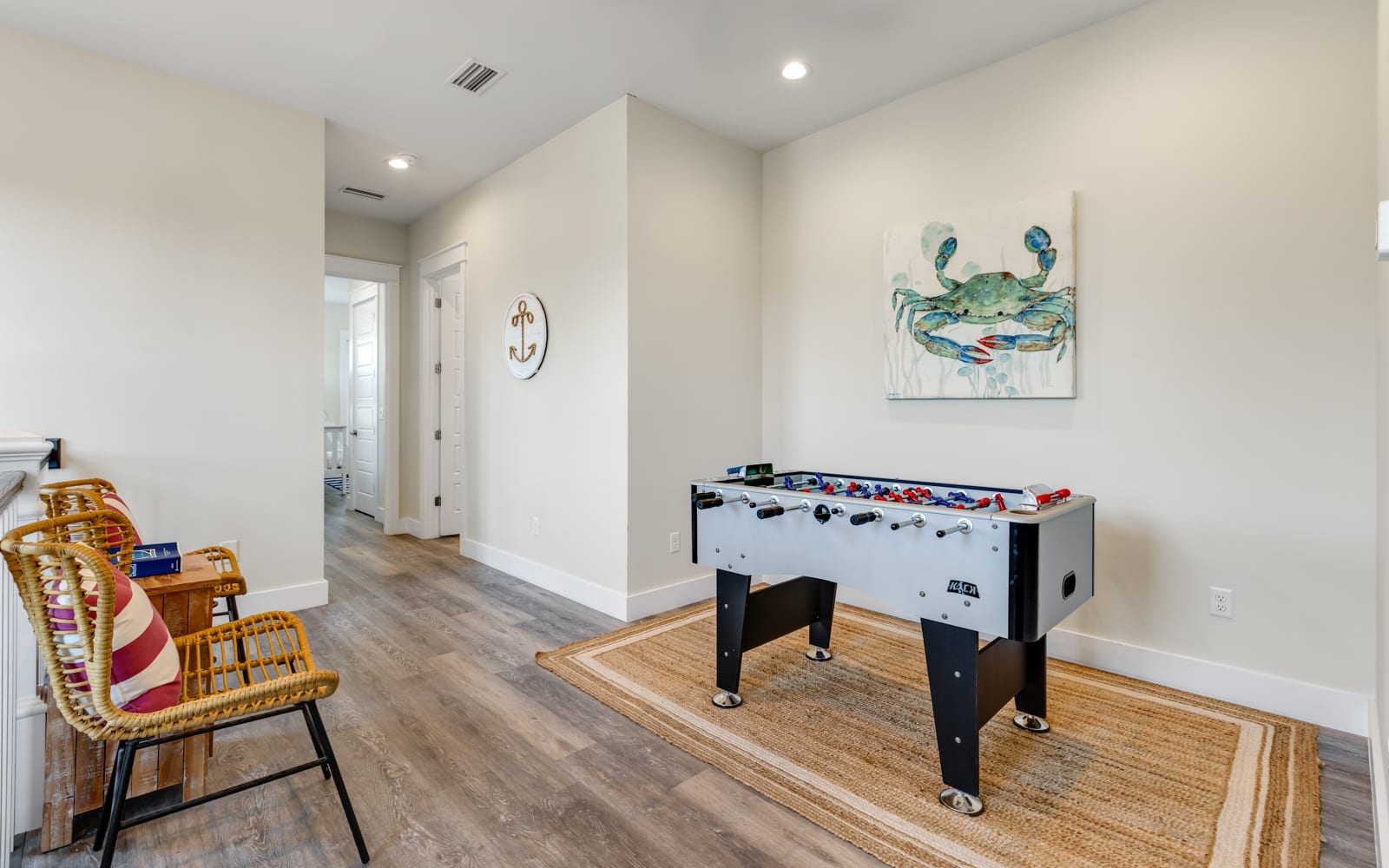 Challenge friends to foosball games in your dedicated game space, where coastal artwork and comfy seating create the perfect entertainment retreat.